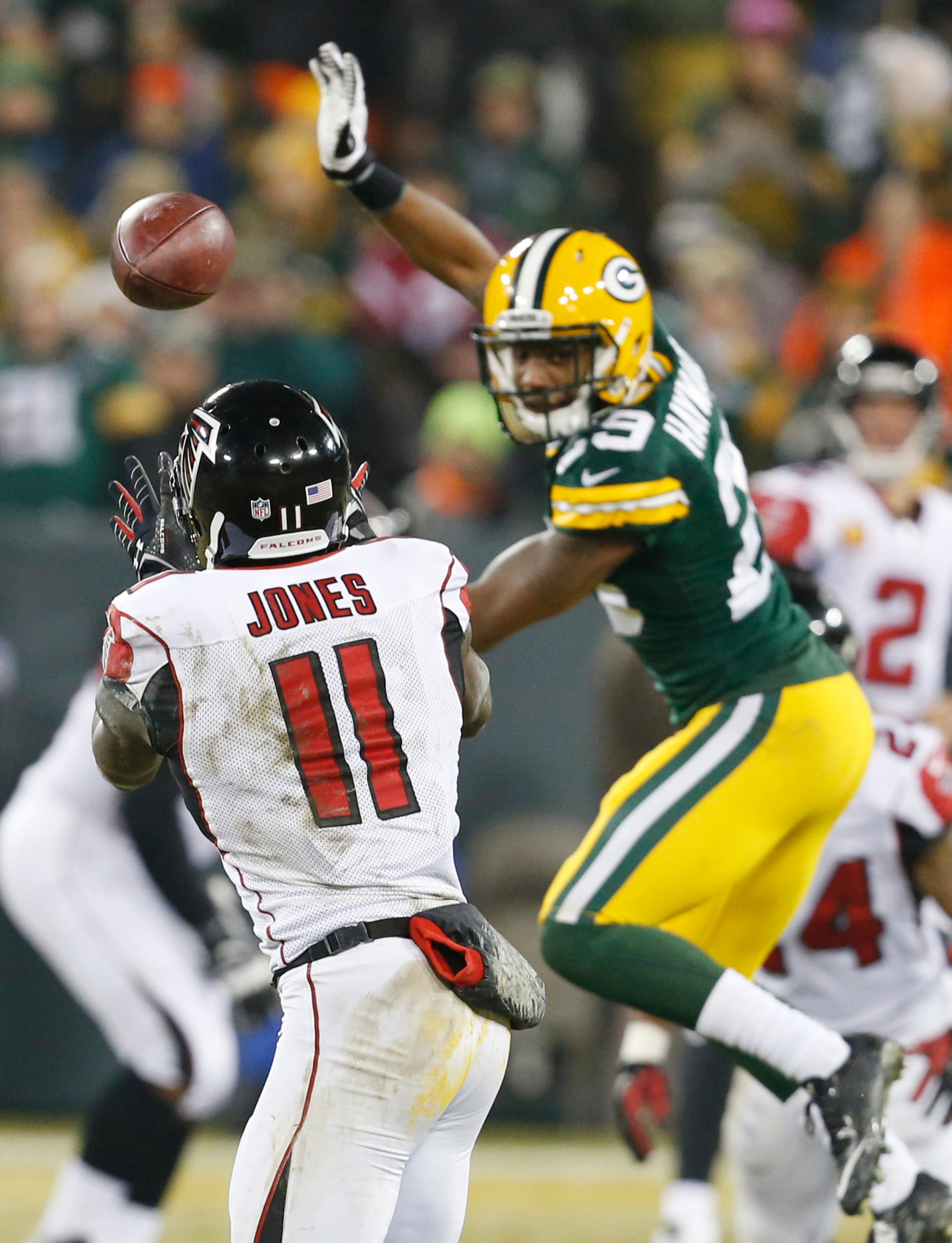 Atlanta Falcons' Julio Jones (11) catches a pass in front of Green Bay Packers' Casey Hayward (29) during the first half Monday, Dec. 8, 2014, in Green Bay, Wis.