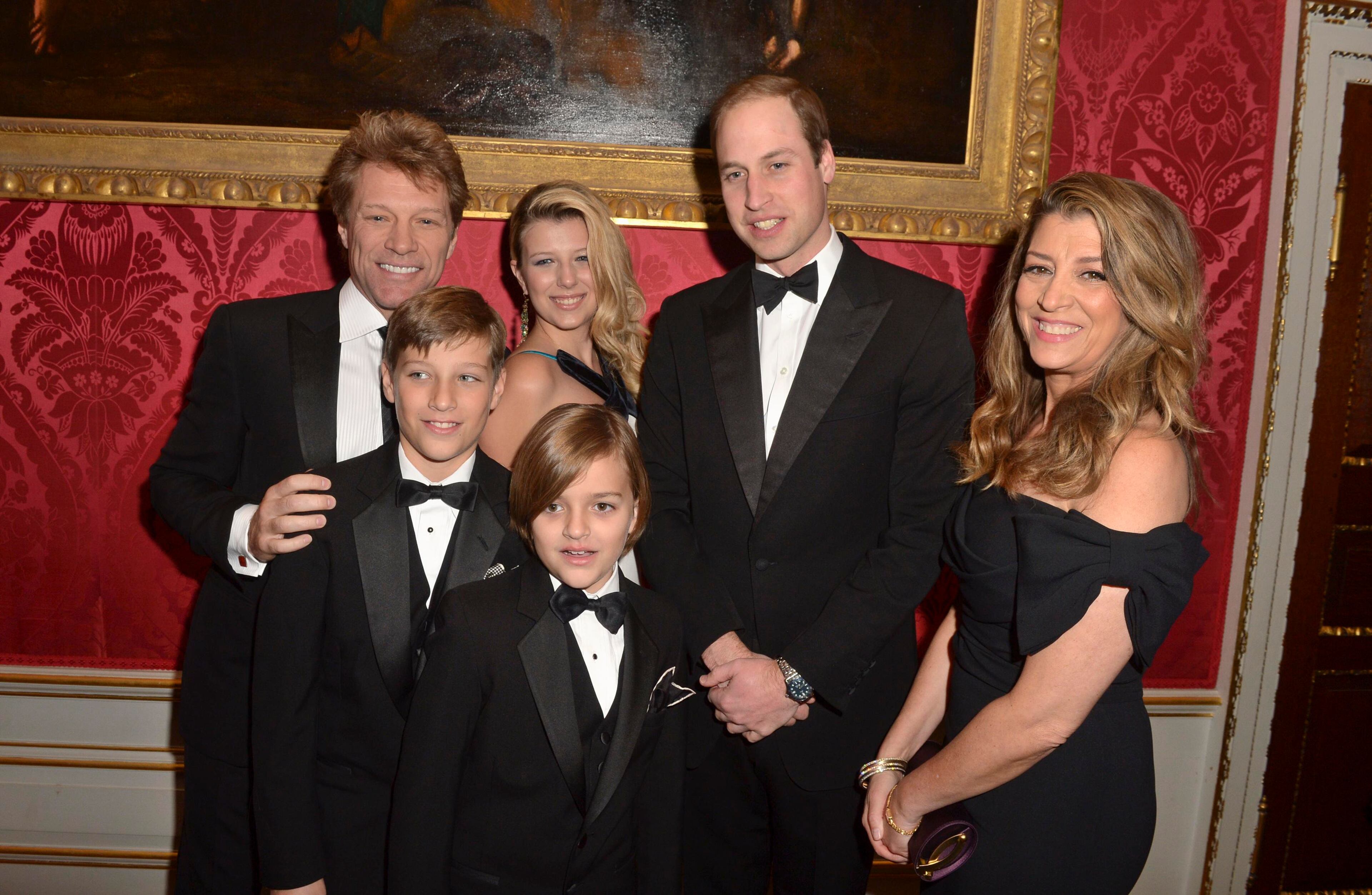 Britain's Prince William, The Duke of Cambridge, meets musician Jon Bon Jovi (left) and wife Dorothea Hurley (right) and their children Jacob (second left), Stephanie (third left) and Romeo (front, fourth left) during the Centrepoint Gala Dinner at Kensington Palace in London on Nov. 26, 2013.