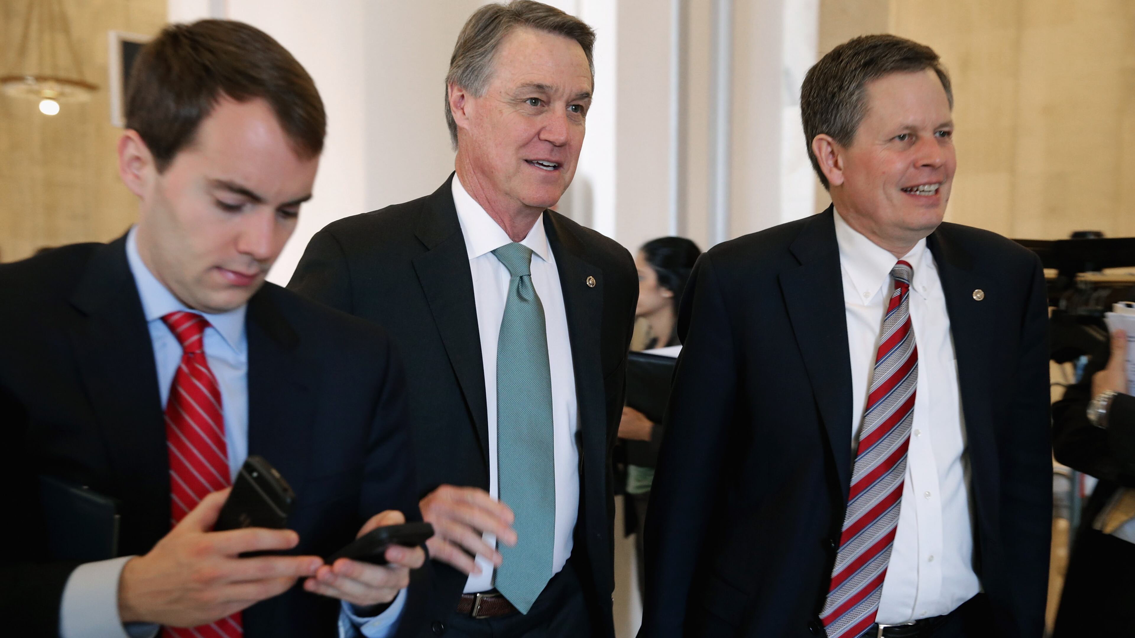 WASHINGTON, DC - FEBRUARY 04: Sen. David Perdue (R-GA) (C) and Sen. Steve Daines (R-MT) (R) leave a Senate bipartisan lunch in the Russell Senate Office Building on Capitol Hill February 4, 2015 in Washington, DC. Senators from both parties said they did not talk about current legislation during the lunch and said they plan to continue the bipartisan lunch once every month. (Photo by Chip Somodevilla/Getty Images)