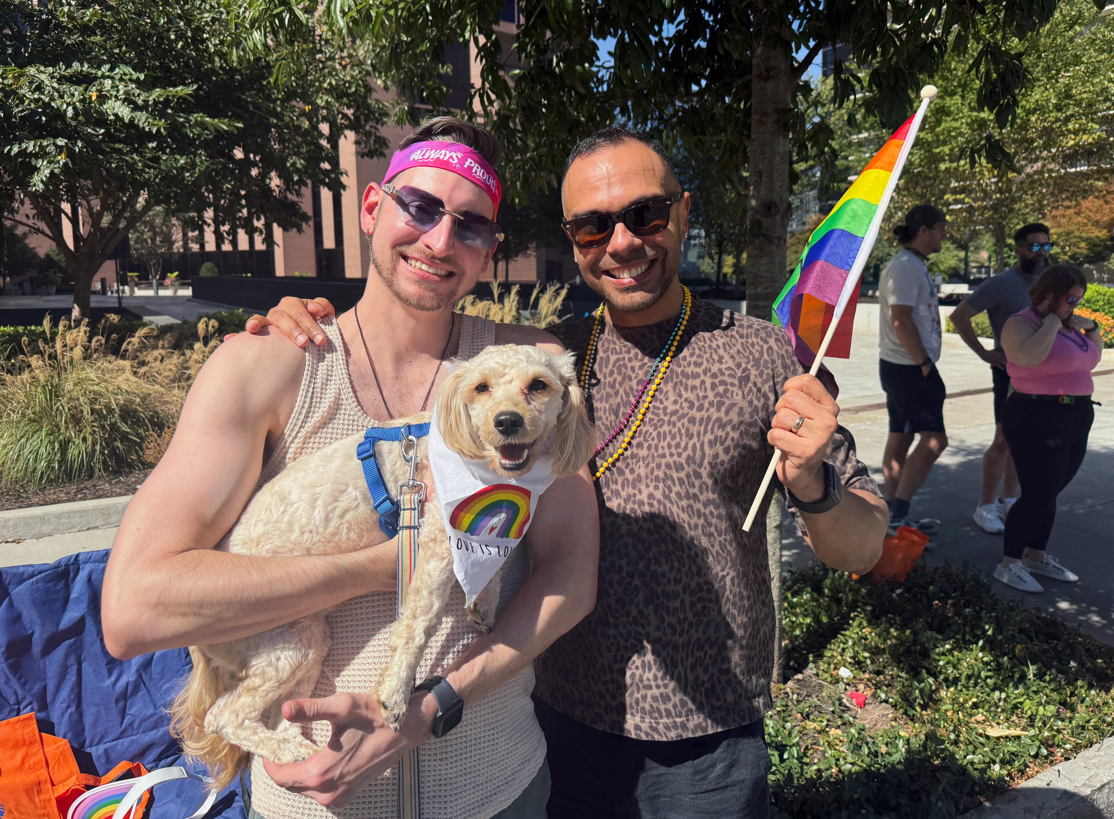 Chris Butler (left), 33, and Jose Luis Sucre, 29, from Smyrna came to the parade with their dog, Canela. The couple has been married for five years. (Danielle Charbonneau/AJC)