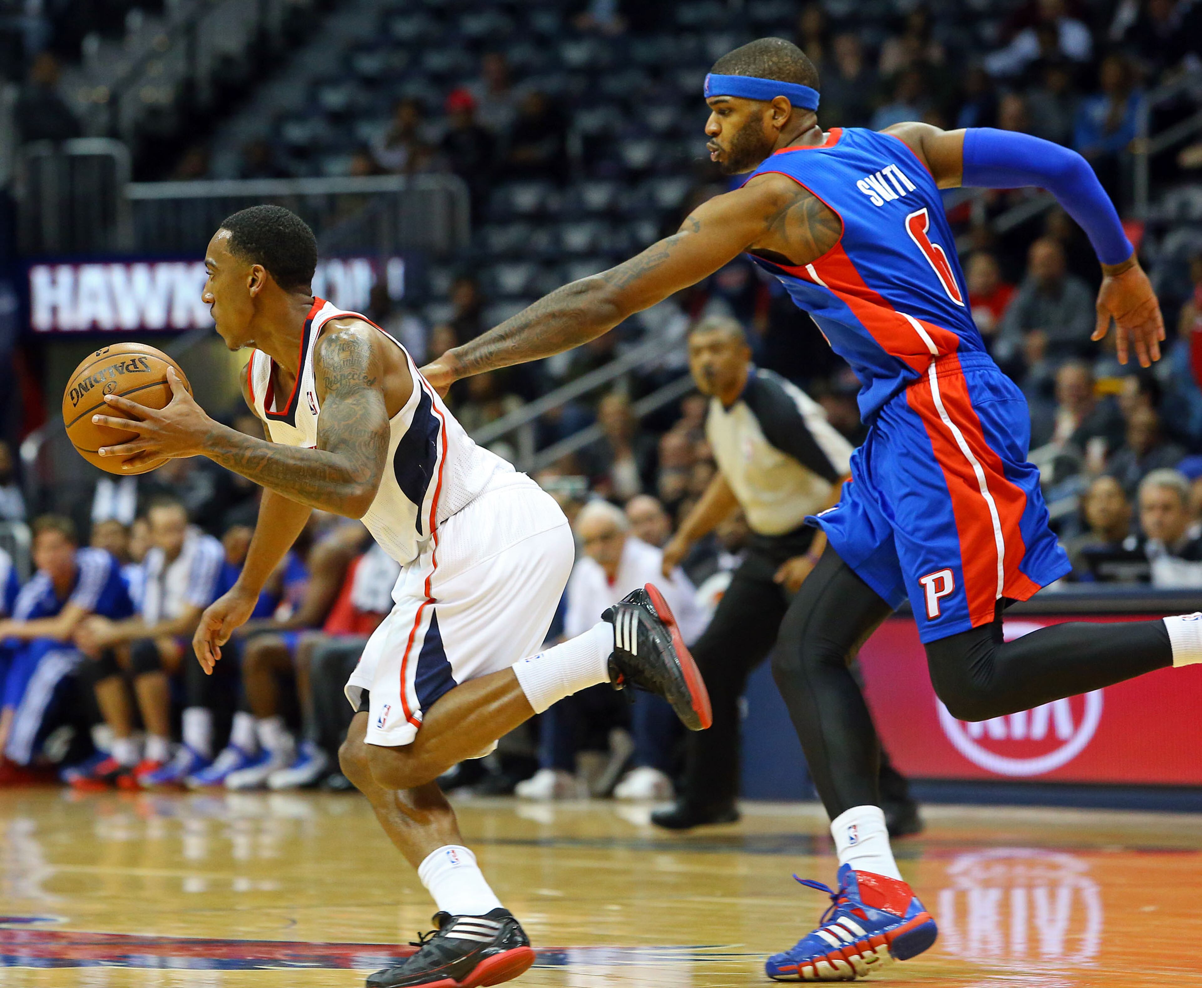 112013 ATLANTA: Hawks guard Jeff Teague breaks away from Pistons forward Josh Smith on the way to a 93-85 Hawks victory during the second half of their NBA basketball game in Smith's first return home against his former team on Wednesday, Nov. 20, 2013, in Atlanta. CURTIS COMPTON /staff CCOMPTON@AJC.COM Josh Smith, shown chasing Jeff Teague in a game last season, returned to Atlanta for an exhibition game Saturday.