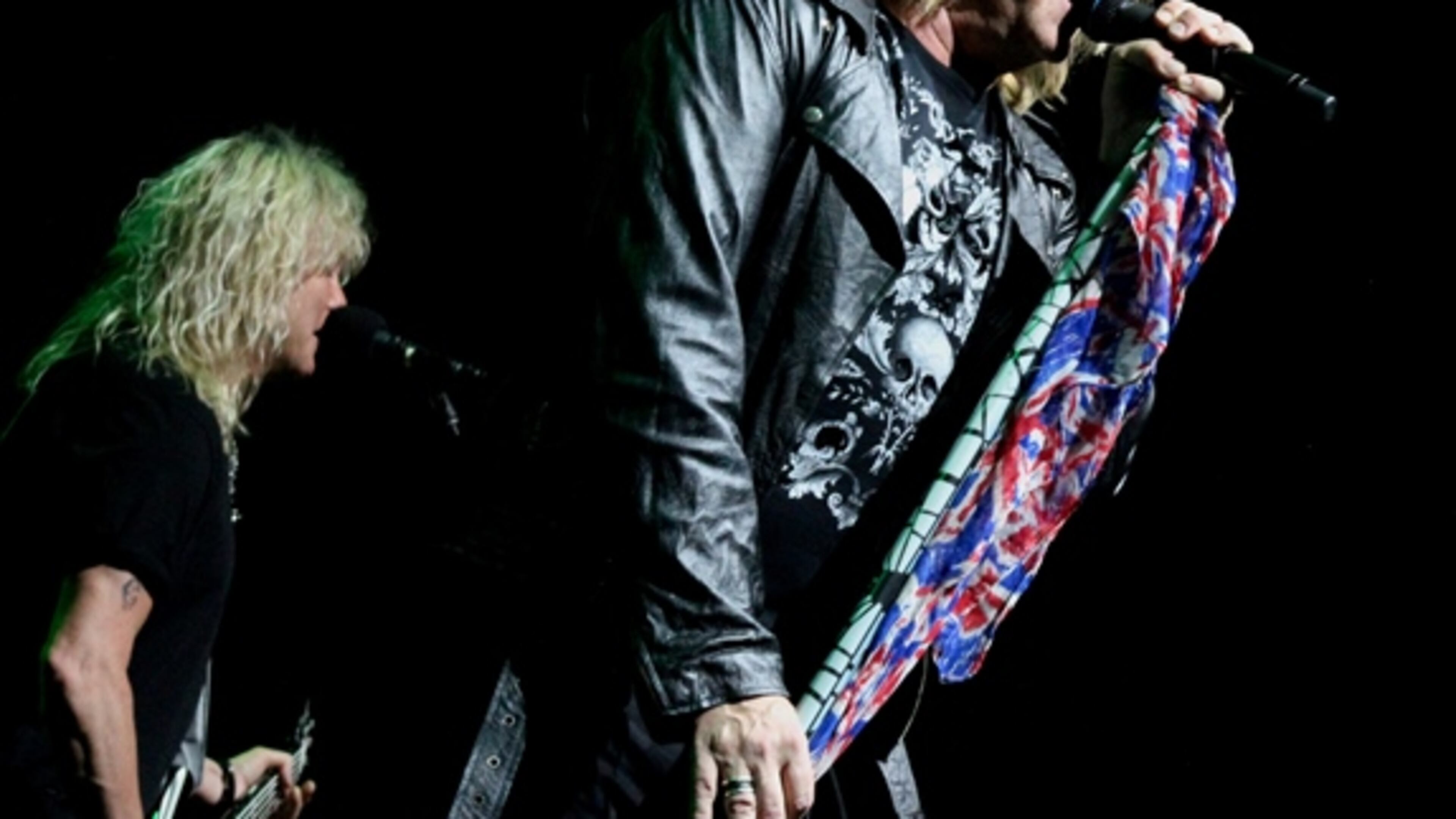 Def Leppard singer Joe Elliott with bassist Rick Savage in the background. The band, along with Poison and Tesla, packed Lakewood Amphitheatre on May 3, 2017. Photo: Melissa Ruggieri/AJC