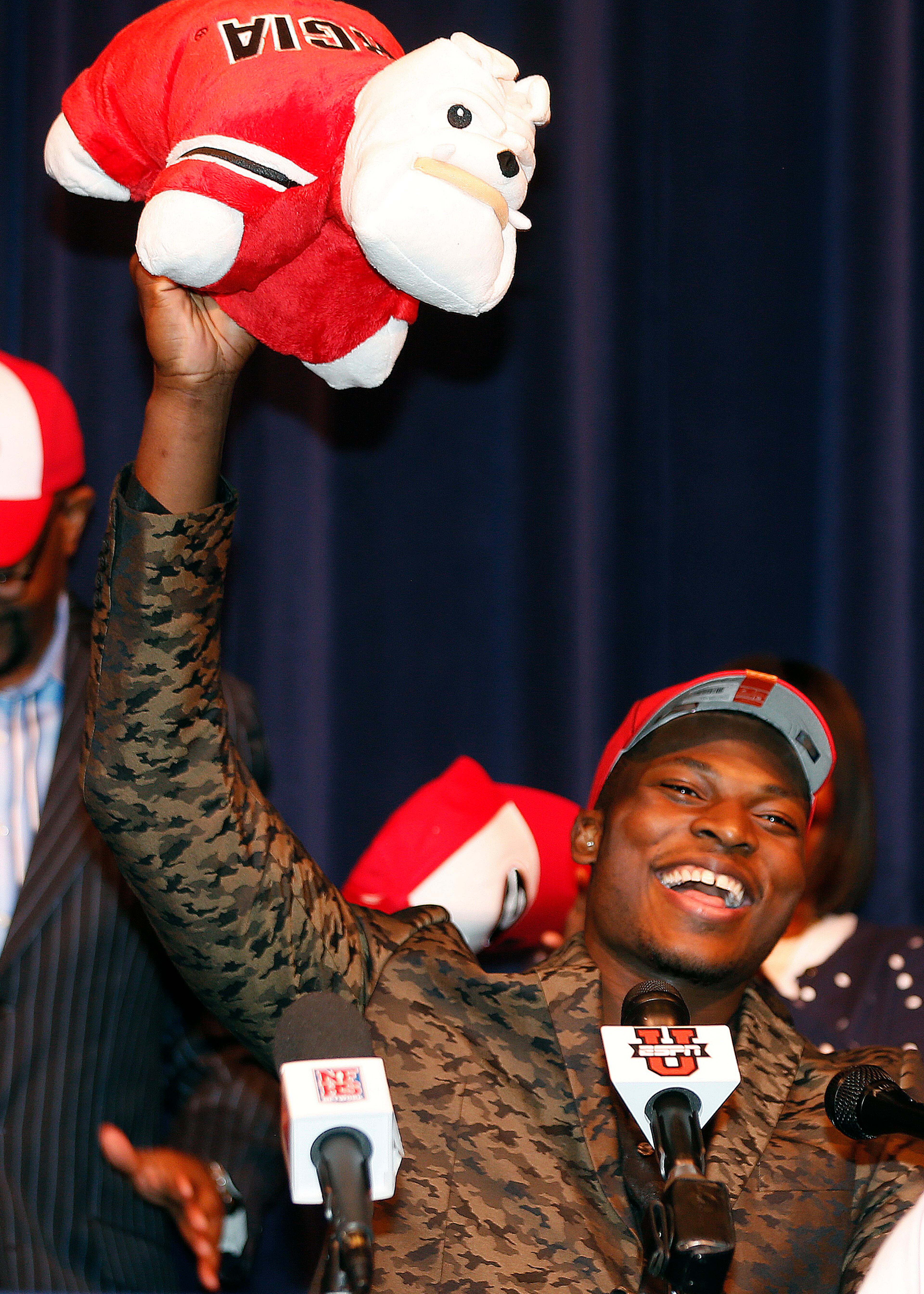 Norcross High School defensive end Lorenzo Carter holds up a stuffed bulldog as he announces that he plans to play NCAA college football at Georgia at during a news conference, Wednesday, Feb. 5, 2014, in Norcross, Ga. Carter is regarded as the top prospect in Georgia and one of the top pass-rushers in the nation.