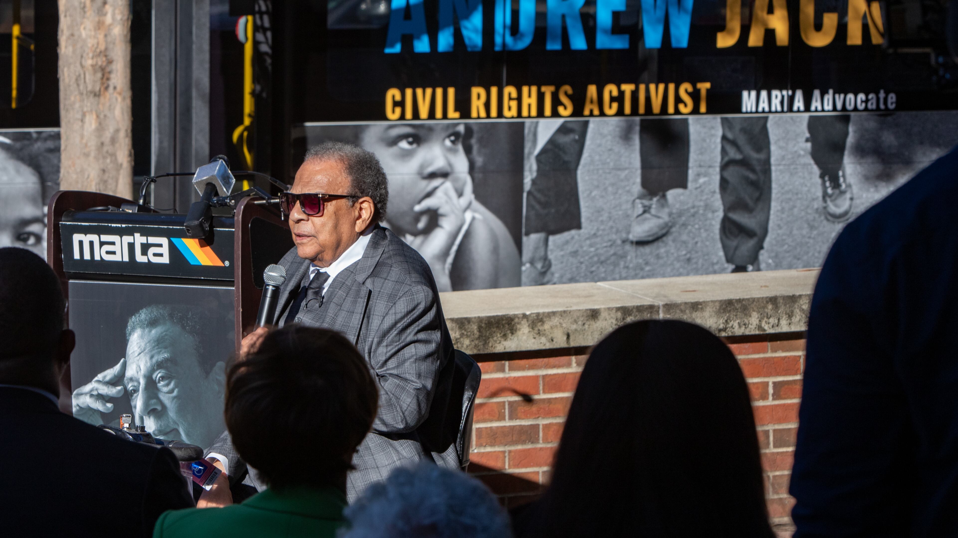 At a ceremony unveiling a new MARTA bus featuring Andrew Young, the former Atlanta Mayor Andrew Young speaks at the event with the new bus behind him where he is among six mayors at the event at the Ray Charles Performing Arts Center at Morehouse College on Friday, November 15, 2024. (Jenni Girtman for The Atlanta Journal-Constitution)
