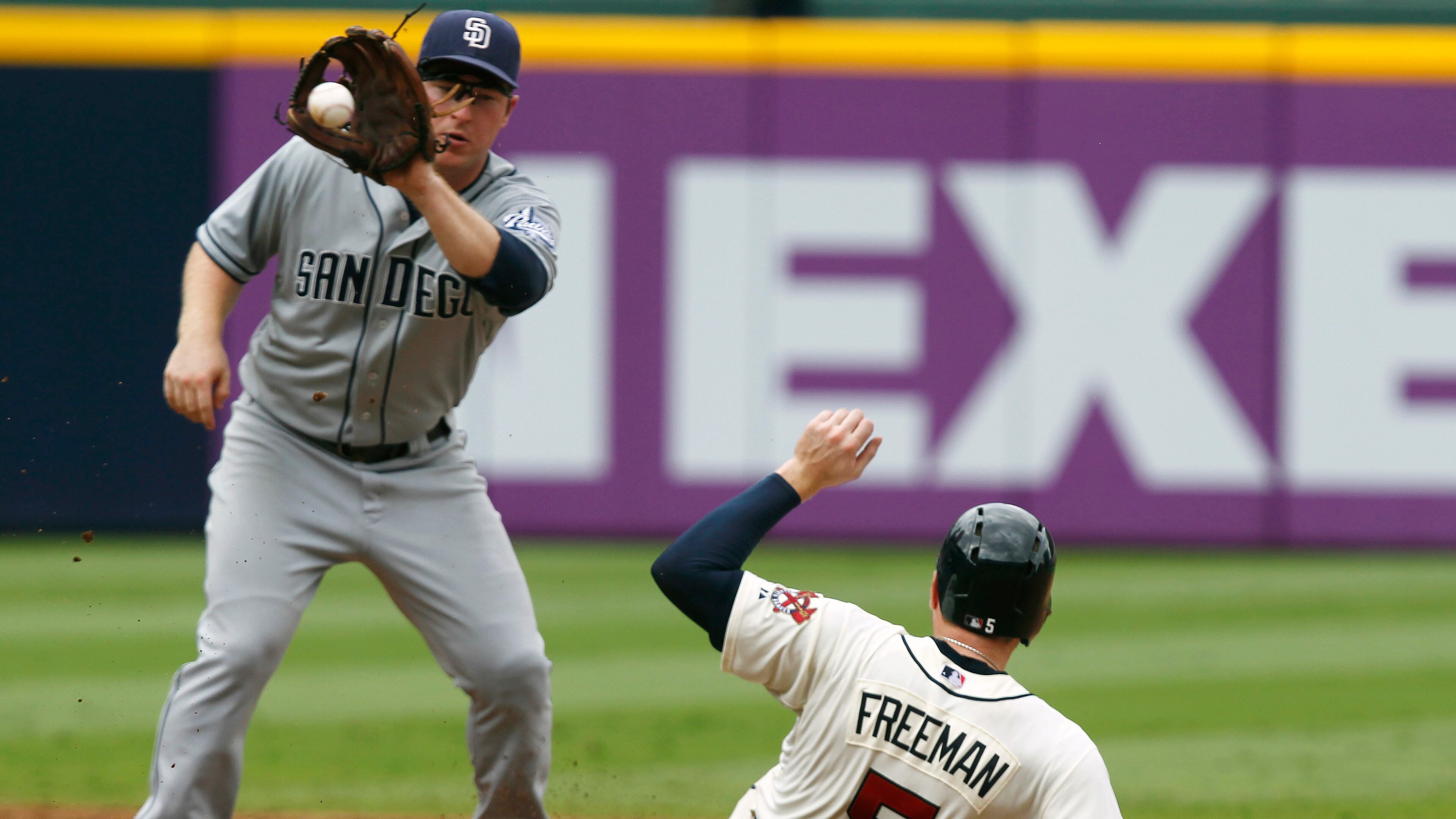 Atlanta Braves Freddie Freeman slides safely into second before the tag from San Diego Padres Jedd Gyorko in the fifth inning of a baseball game at Turner Field on Sunday, Sept. 15, 2013, in Atlanta.