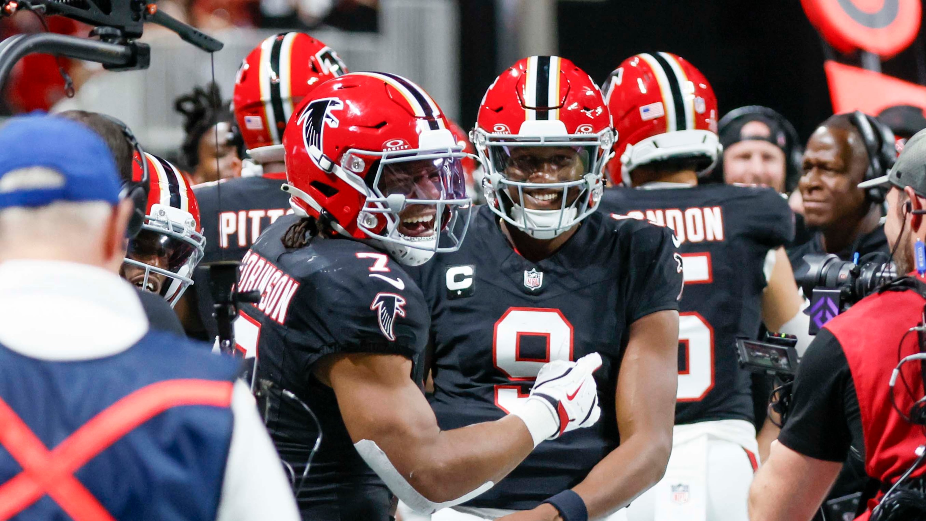 Falcons' running back Bijan Robinson (left) continues to be dominant, which has allowed quarterback Michael Penix Jr. to not have to do too much. (Miguel Martinez/AJC)