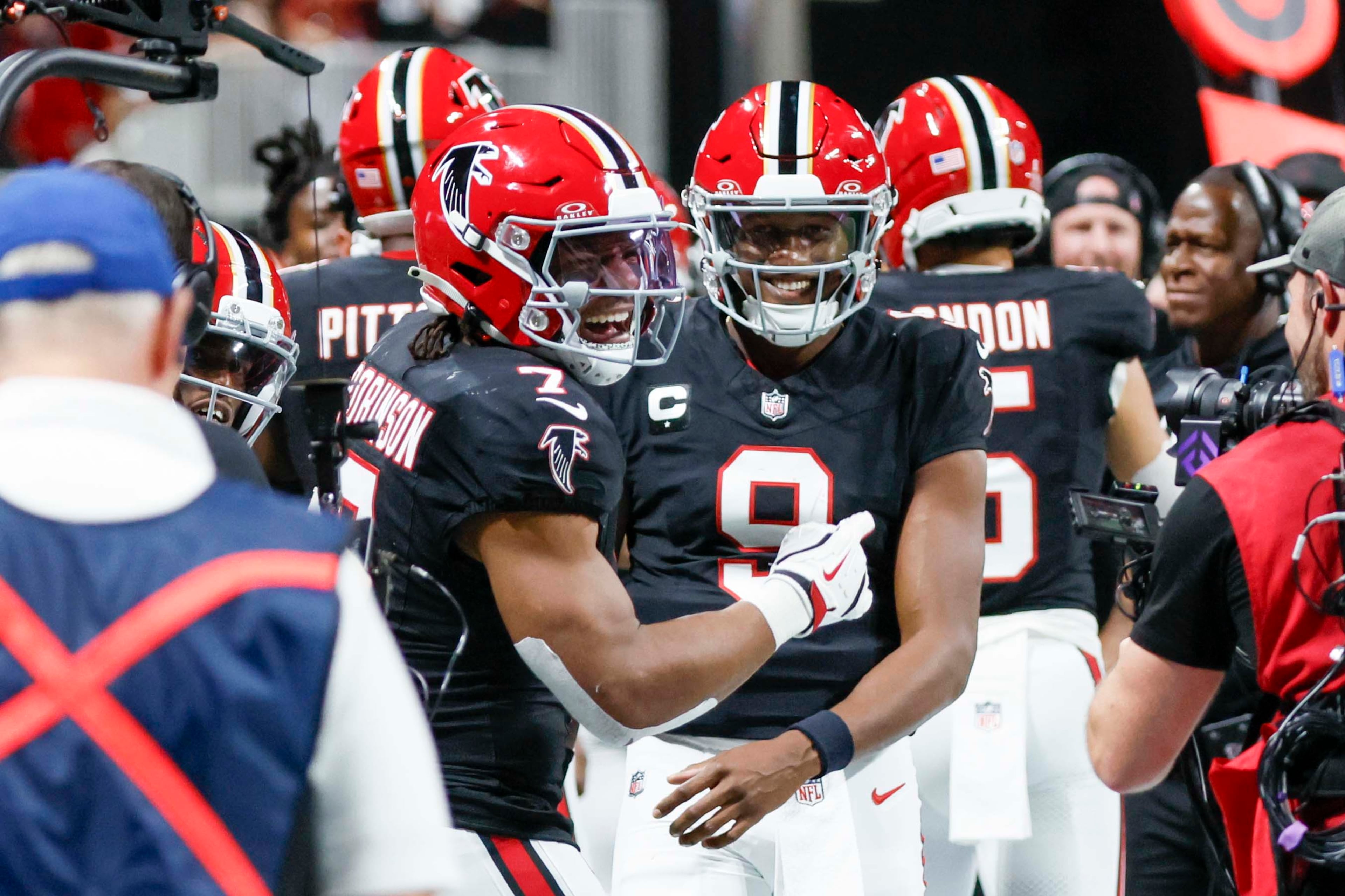 Atlanta Falcons running back Bijan Robinson (left) celebrates with Atlanta Falcons quarterback Michael Penix Jr. (right) after his touchdown during the first half of an NFL football game against the Buffalo Bills at Mercedes-Benz Stadium in Atlanta on Monday, October 13, 2025. (Miguel Martinez/AJC)