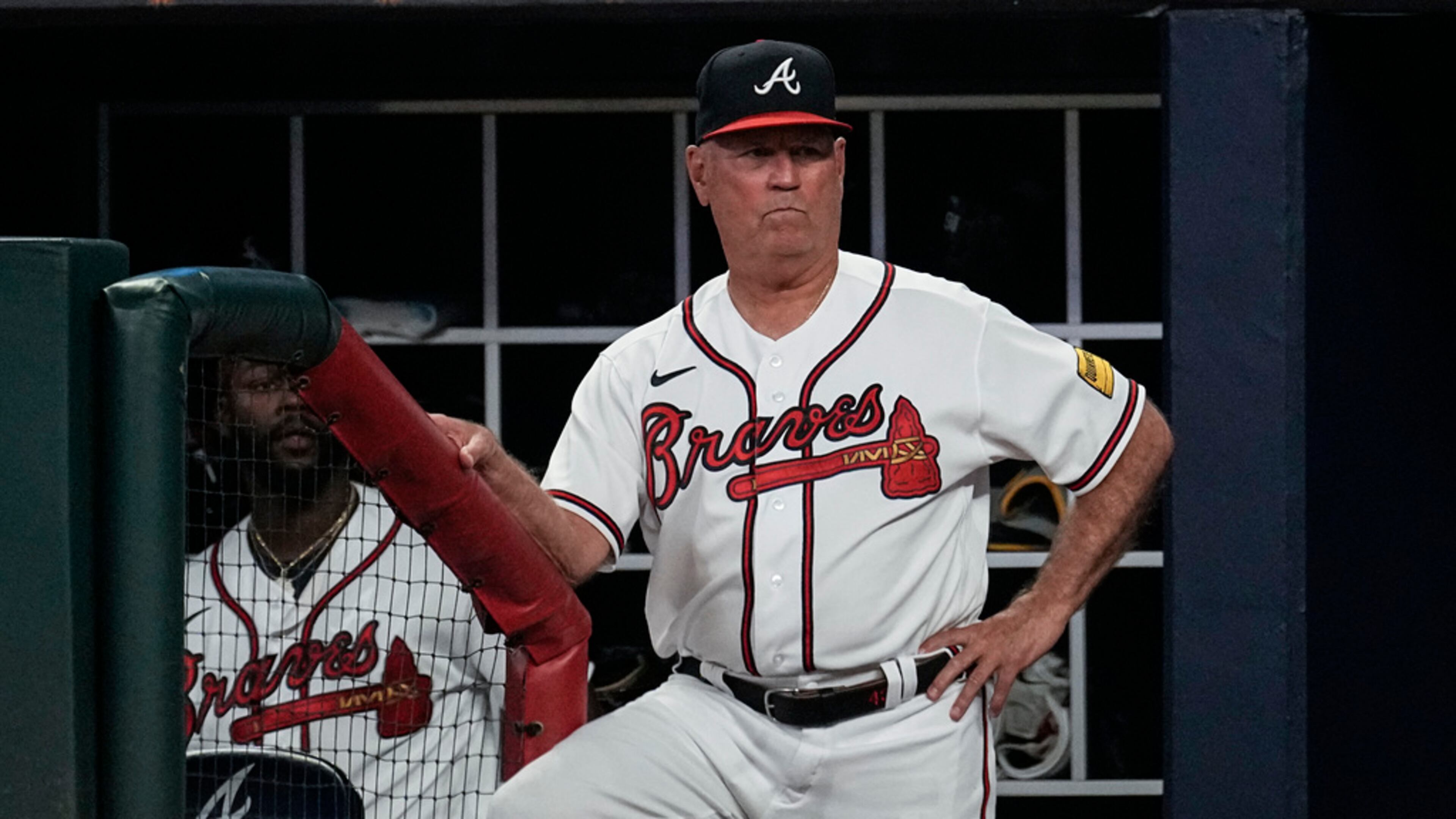 Braves manager Brian Snitker, pictured watching from the dugout in June 2023, praised the way his team "kept fighting" this year despite a slew of injuries that led Atlanta to use an MLB-record 71 players this season. (John Bazemore/AP 2023)