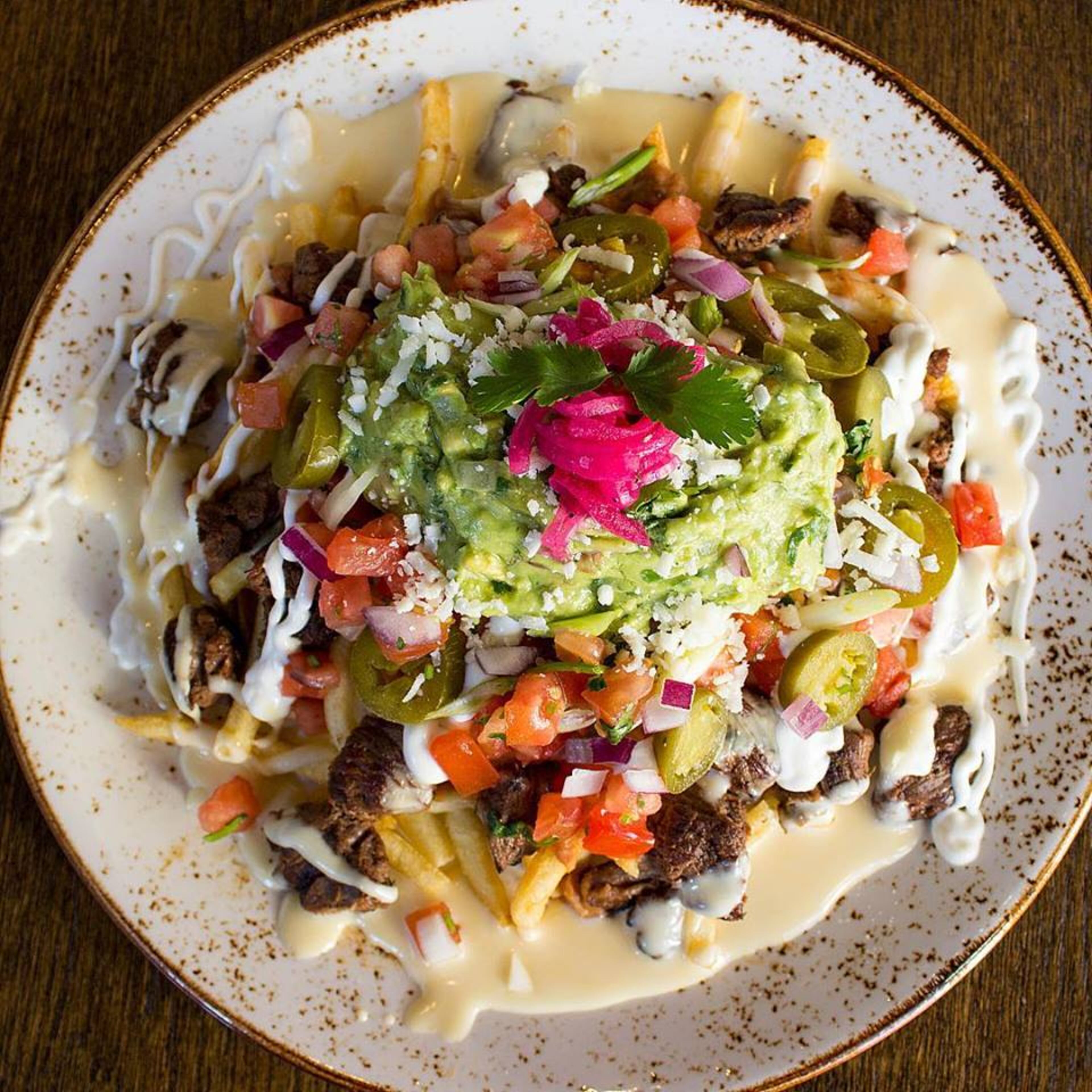 Through Super Bowl Sunday, Patria Cocina in Grant Park will be serving two kinds of L.A.-themed fries, including the California Carne Asada Fries.