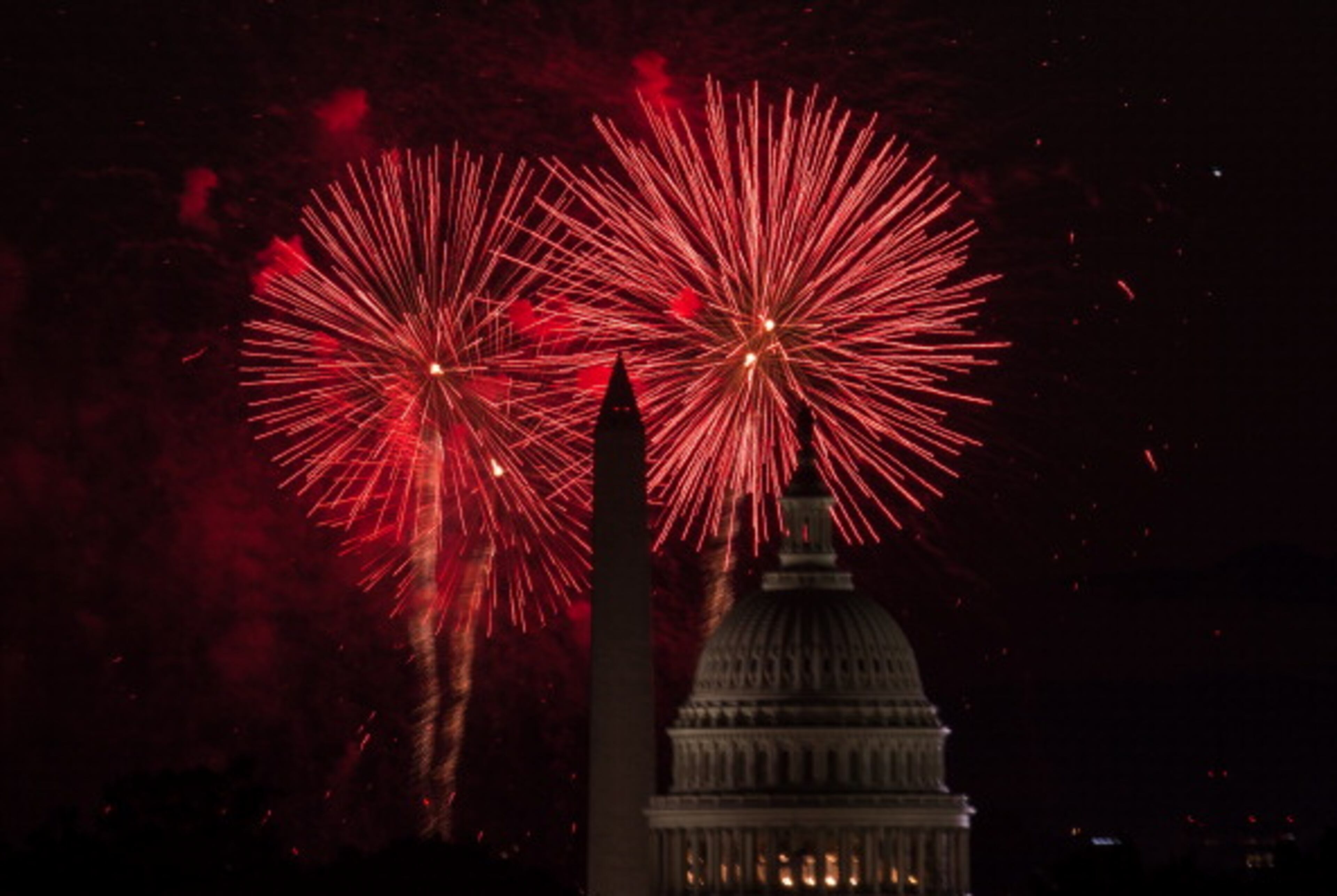 Fireworks burst out over the US Capitol and the Washington Monument during Independence Day celebrations in Washington on July 4, 2014. AFP PHOTO/Nicholas KAMM (Photo credit should read NICHOLAS KAMM/AFP/Getty Images)