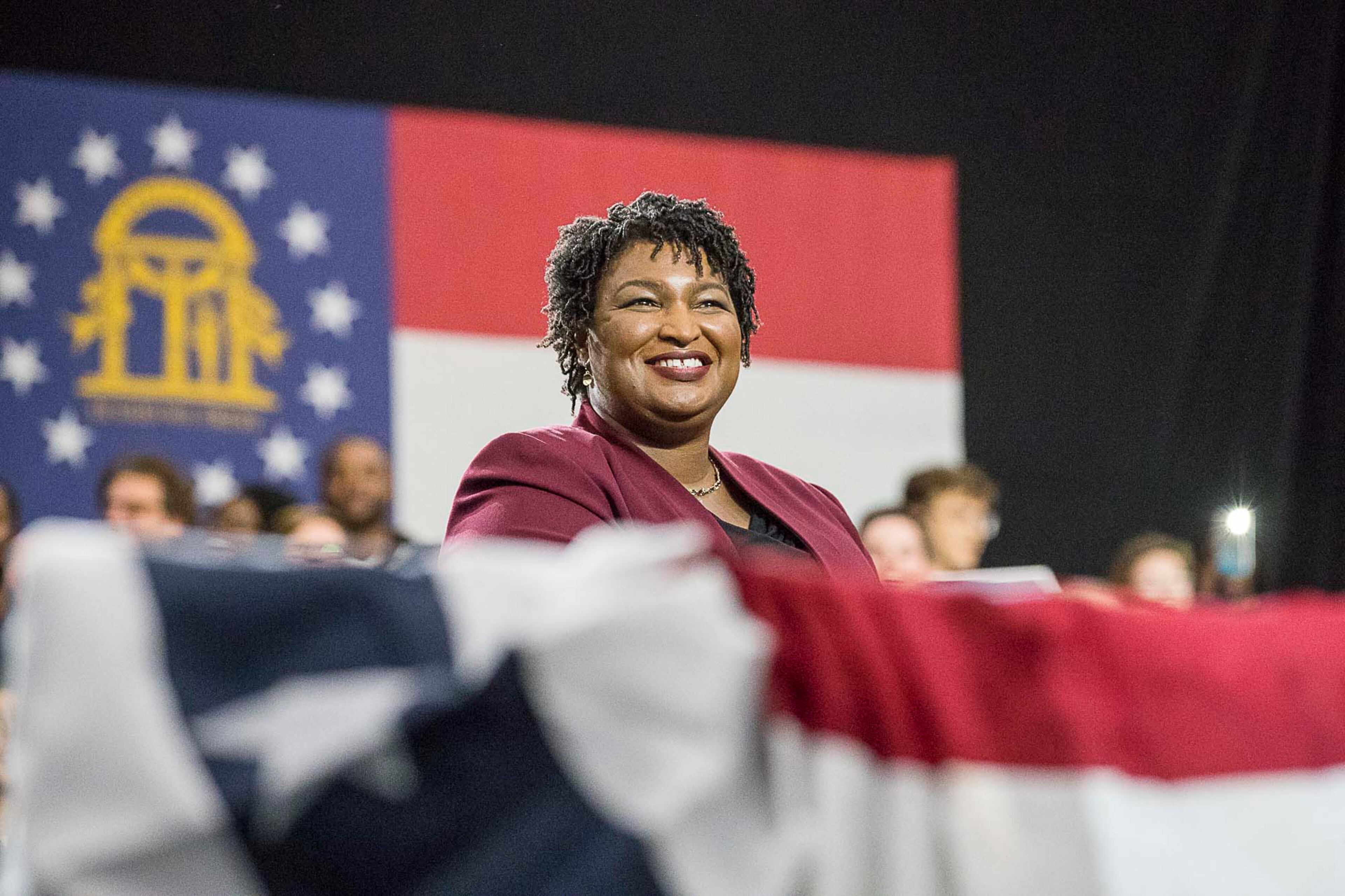 11/02/2018 -- Atlanta, Georgia -- Georgia Gubernatorial candidate Stacey Abrams listens as former President Barack Obama speaks during a rally for in Forbes Arena at Morehouse College, Friday, November 2, 2018. (ALYSSA POINTER/ALYSSA.POINTER@AJC.COM)