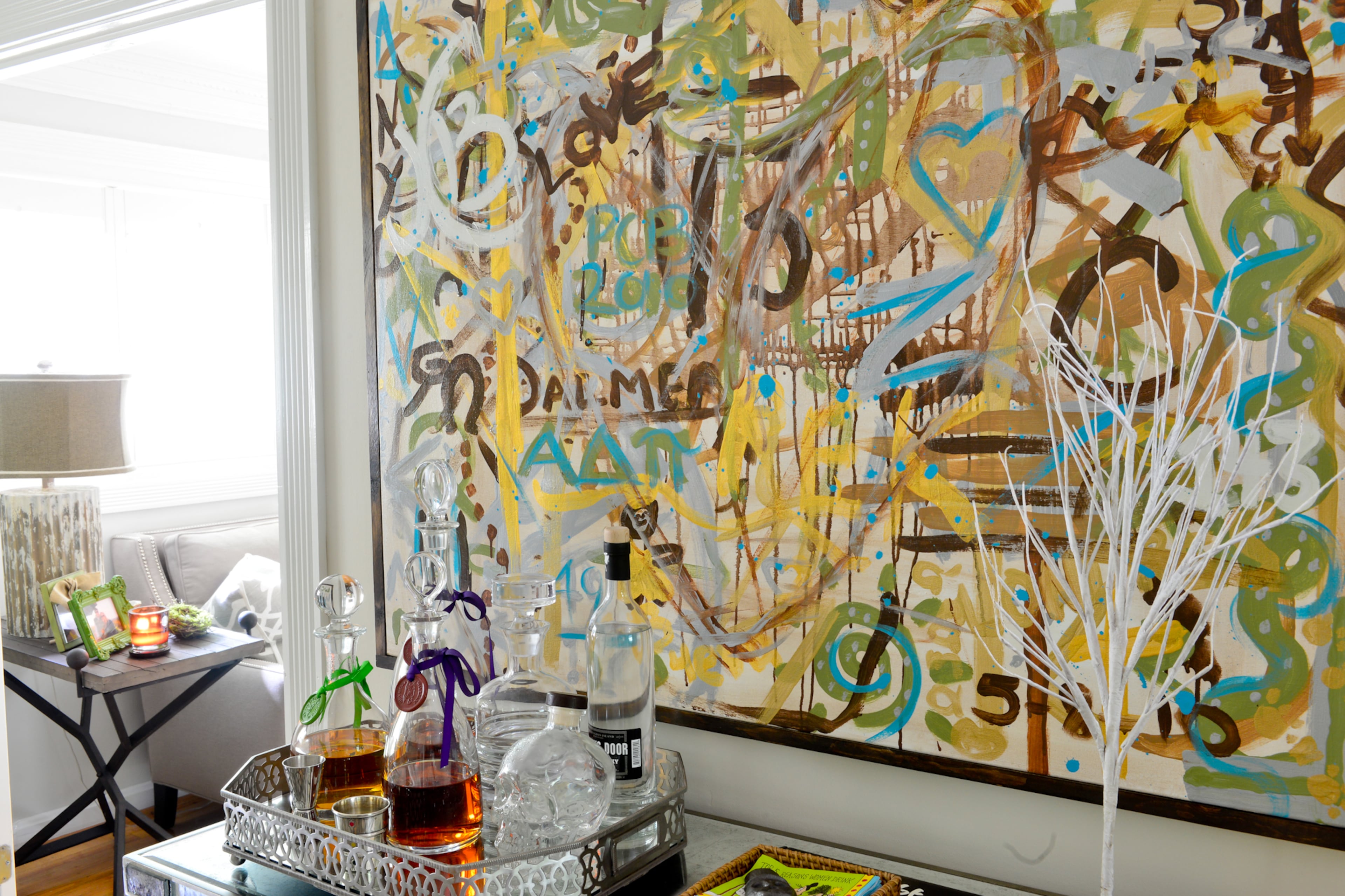A painting above the mirrored bar (from Scott Antique Markets) in the dining room was created by guests at their 2010 wedding. It's a conversation piece that also has an interactive element. "Instead of doing a wedding book when we got married, we did a canvas and let people paint on it and make their mark," Betsy Clay said. "Everybody that comes into the house looks at it and tries to remember what they did on it."