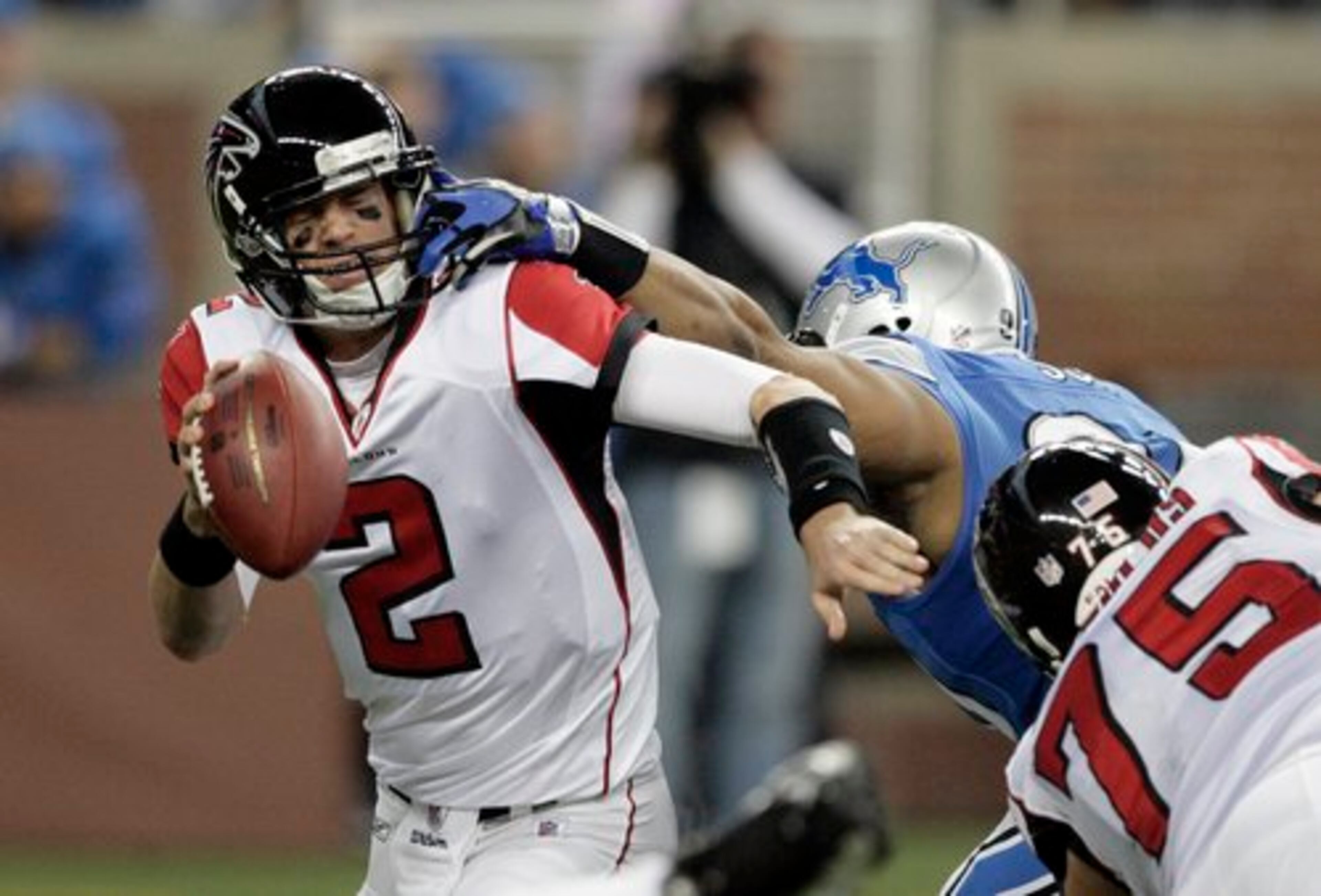 Falcons QB Matt Ryan has his facemask grabbed by Lions DT Ndamukong Suh during first quarter of Sunday's game in Detroit.