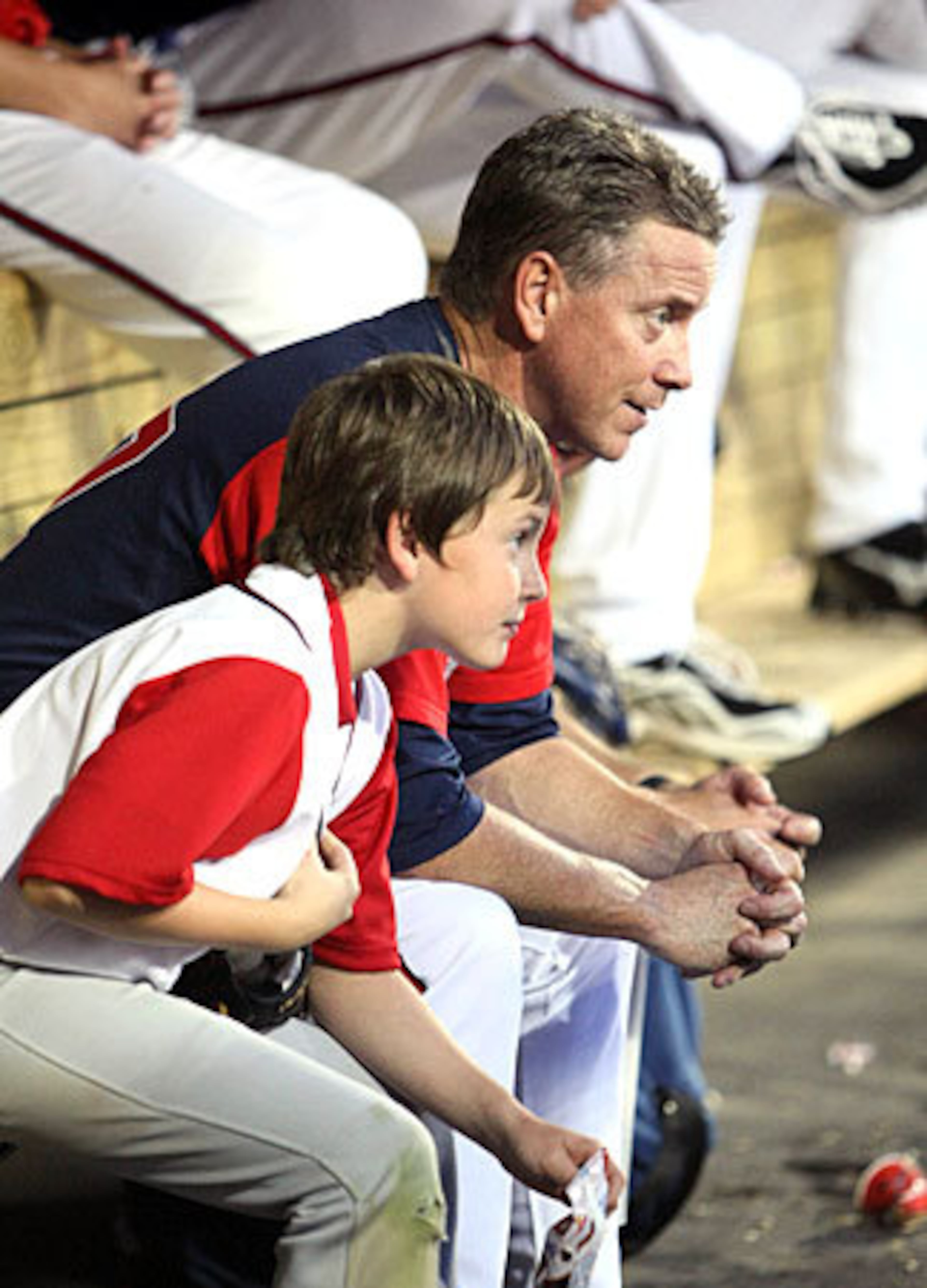 Glavine sits with his son Peyton, 10, in the dugout.