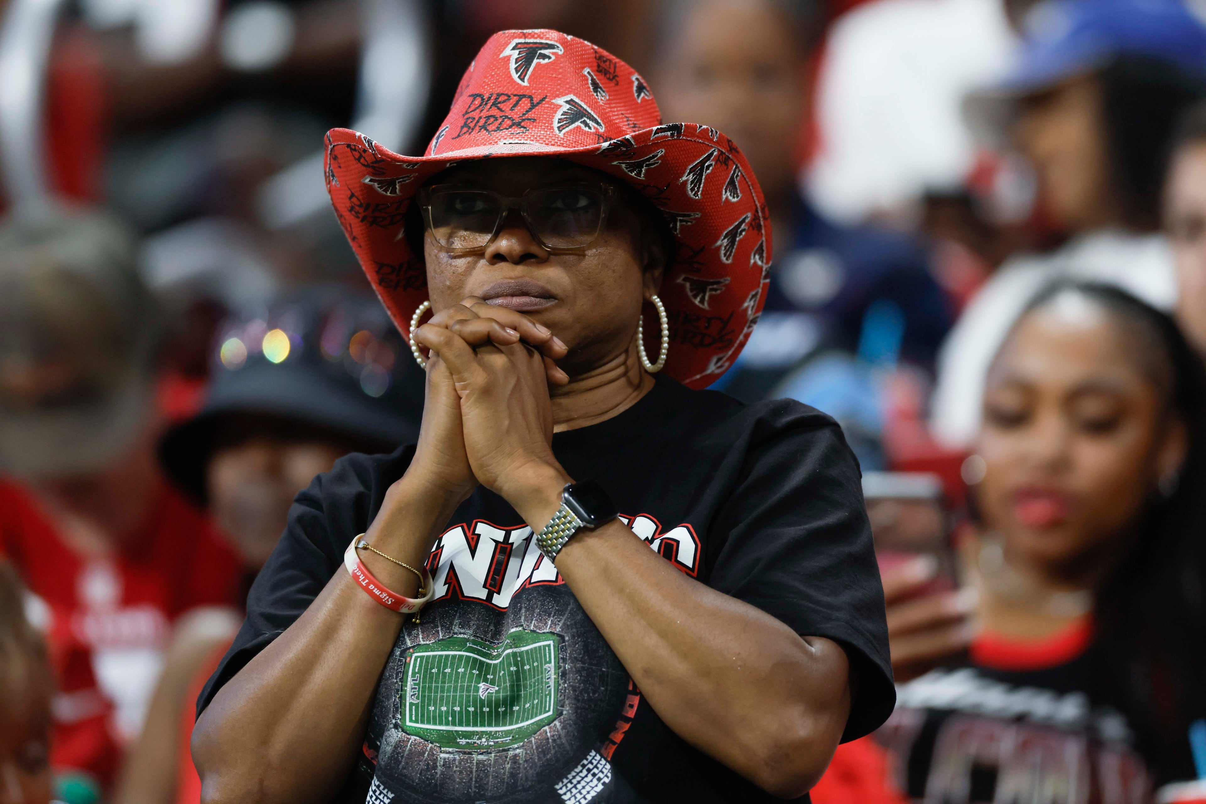 An Atlanta Falcons fan reacts as the team struggles to find answers in the second half of an NFL game against the Carolina Panthers at Mercedes-Benz Stadium in Atlanta on Sunday, Sept. 20, 2026. (Miguel Martinez/AJC)