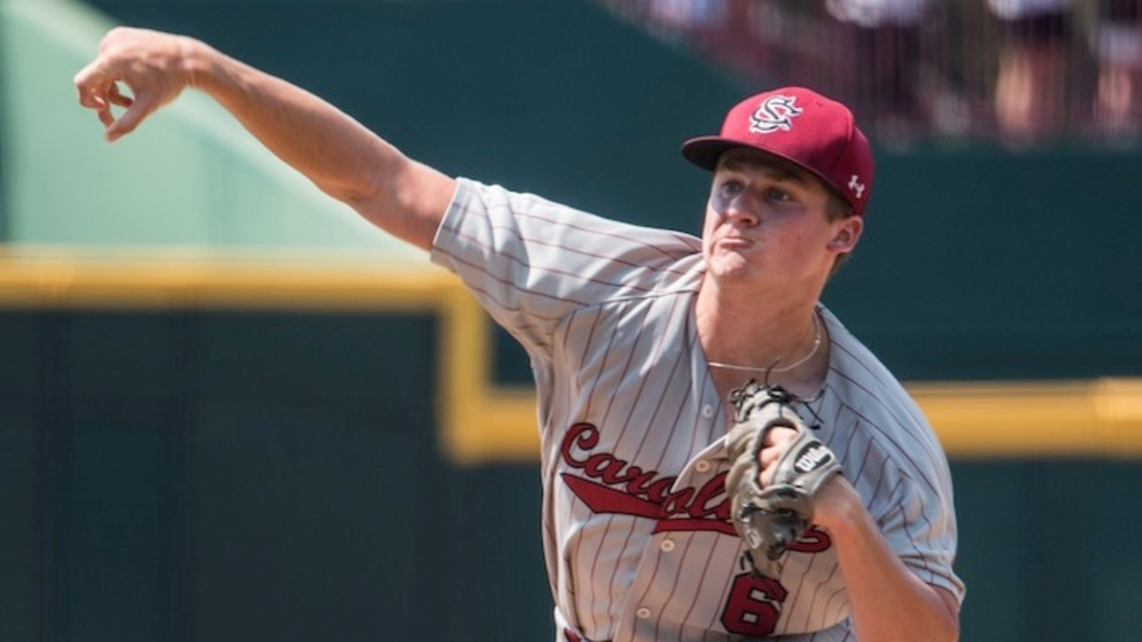 South Carolina pitcher Clarke Schmidt delivers to home plate against Oklahoma State during an NCAA college baseball tournament super regional game Sunday, June 12, 2016, in Columbia, S.C. Oklahoma State defeated South Carolina 3-1 to advance to the College World Series. (AP Photo/Sean Rayford)