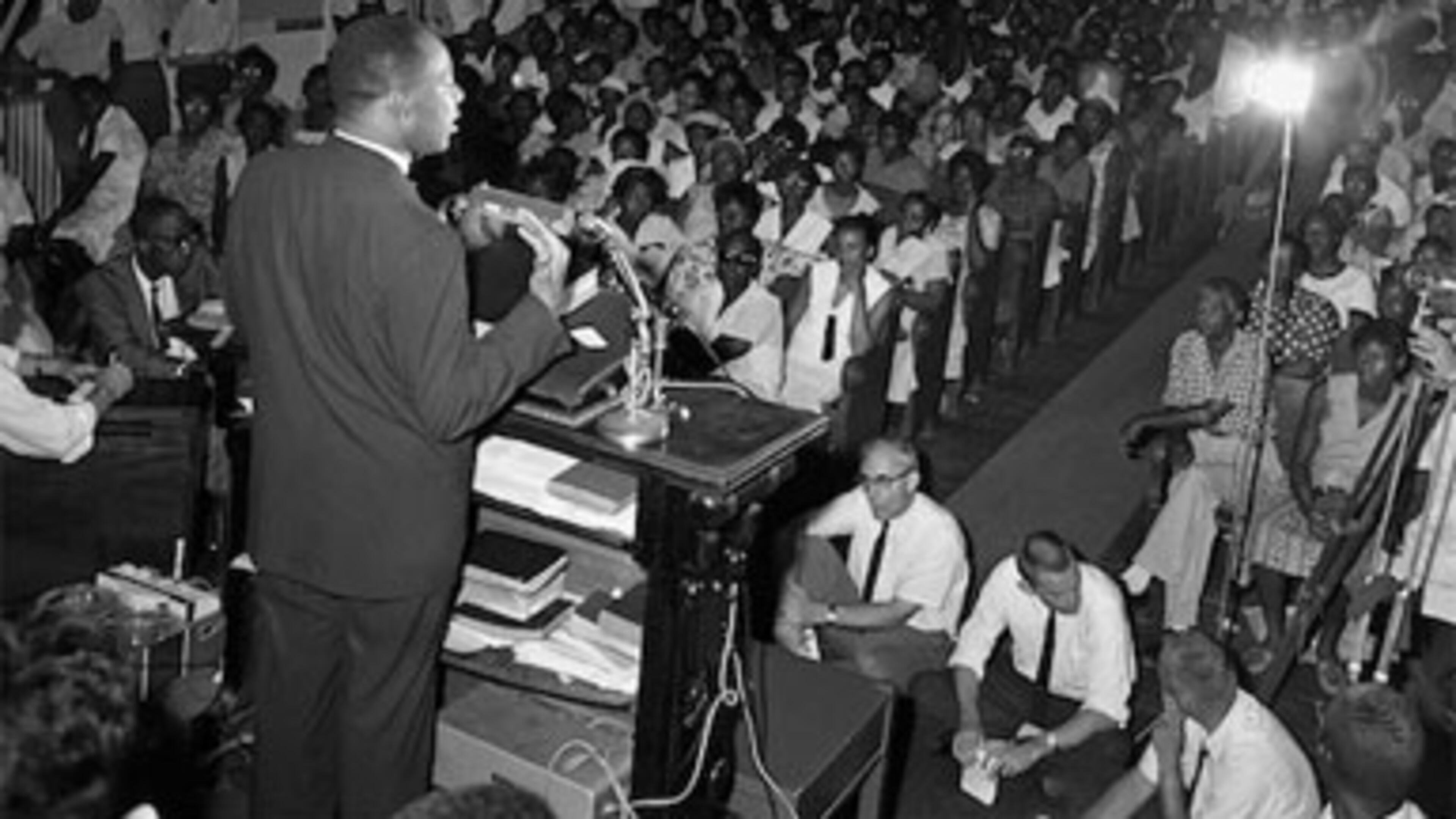 Martin Luther King Jr. talks to a packed church gathering about his "mysterious release" from jail and a later three-hour long conference with city officials in an effort the ease the local racial problems on July 13, 1962, Albany, Ga.
