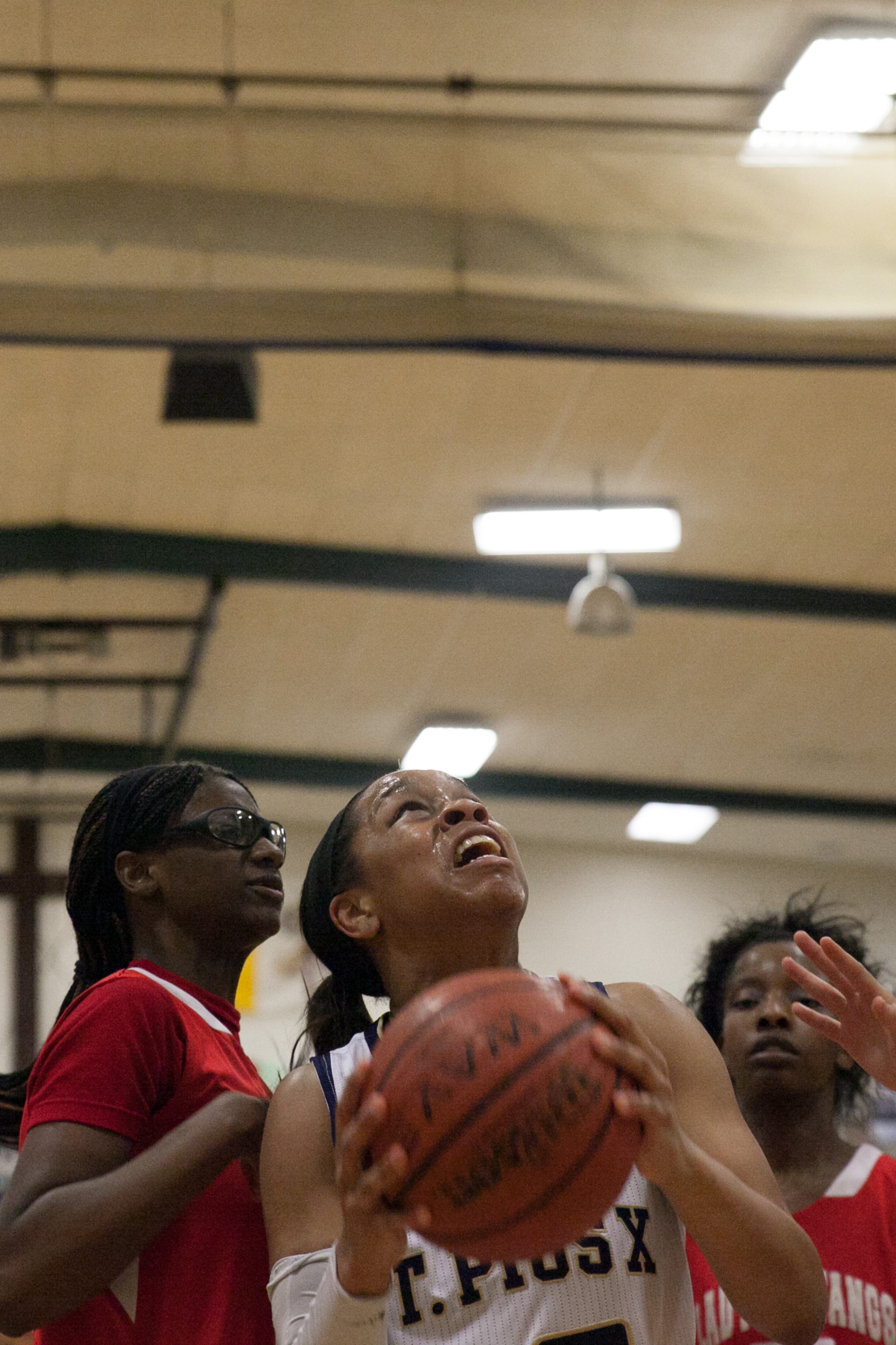 St. Pius player Asia Durr (25) goes in for a lay-up while covered up by McNair players during a high school basketball game on Tuesday, Feb. 4, 2014, in Atlanta, Ga.