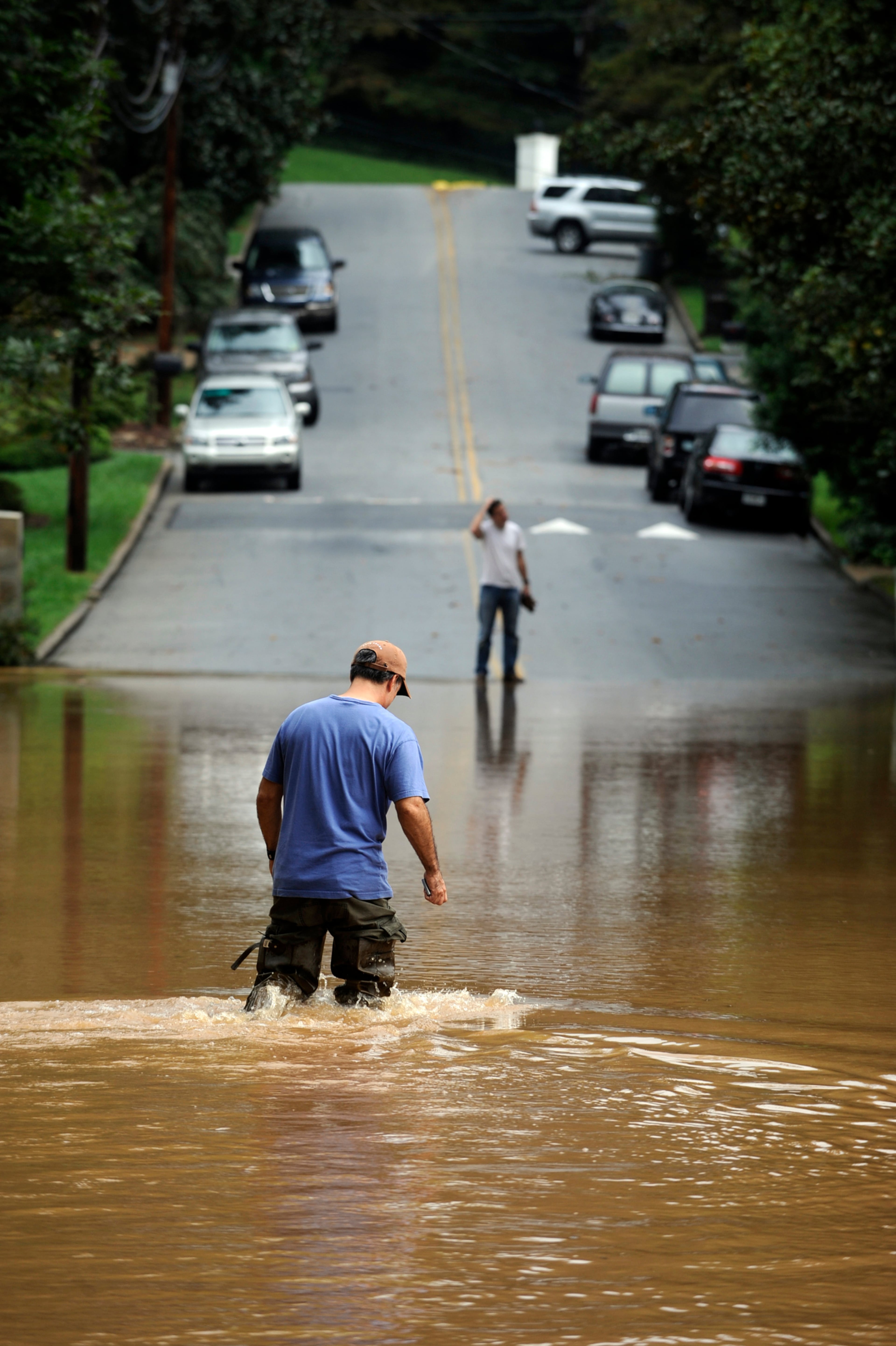 Dean Trevelino, 45, who lives right behind Peachtree Creek, stands in flooded water from the creek up to his knees Monday, Sept. 21, 2009. Trevelino says that five years ago this week, the waters rose to this level due to Hurricane Ivan. "This isn't a hurricane, this is just rain, so in my mind, we've got to do some work on the creek," Trevelino said. "This one totally blinded us." (Photo: Elissa Eubanks/AJC)