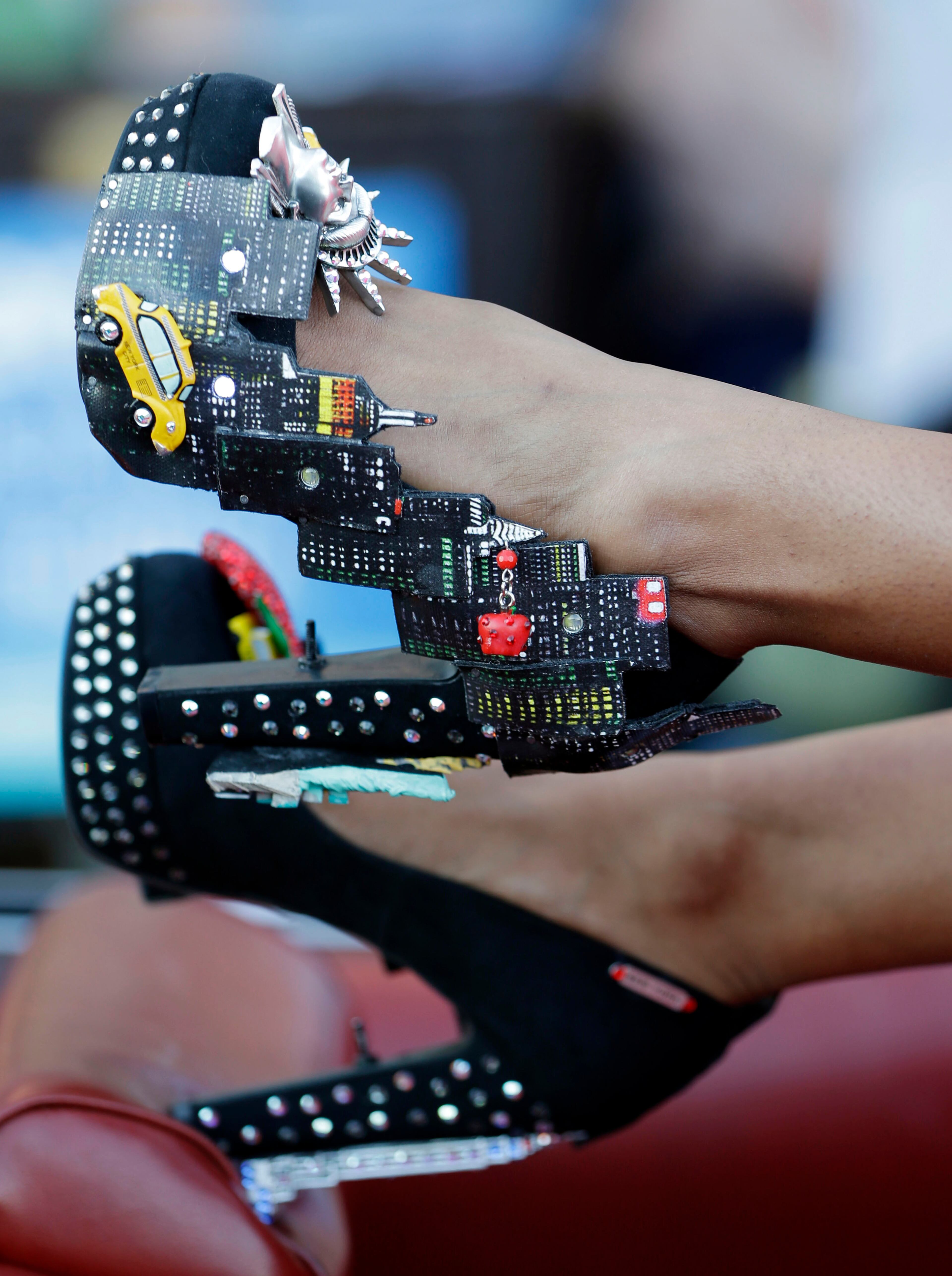 Miss New York Nina Davuluri displays her shoes during the Miss America Shoe Parade at the Atlantic City boardwalk, Saturday, Sept. 14, 2013, in Atlantic City, N.J.