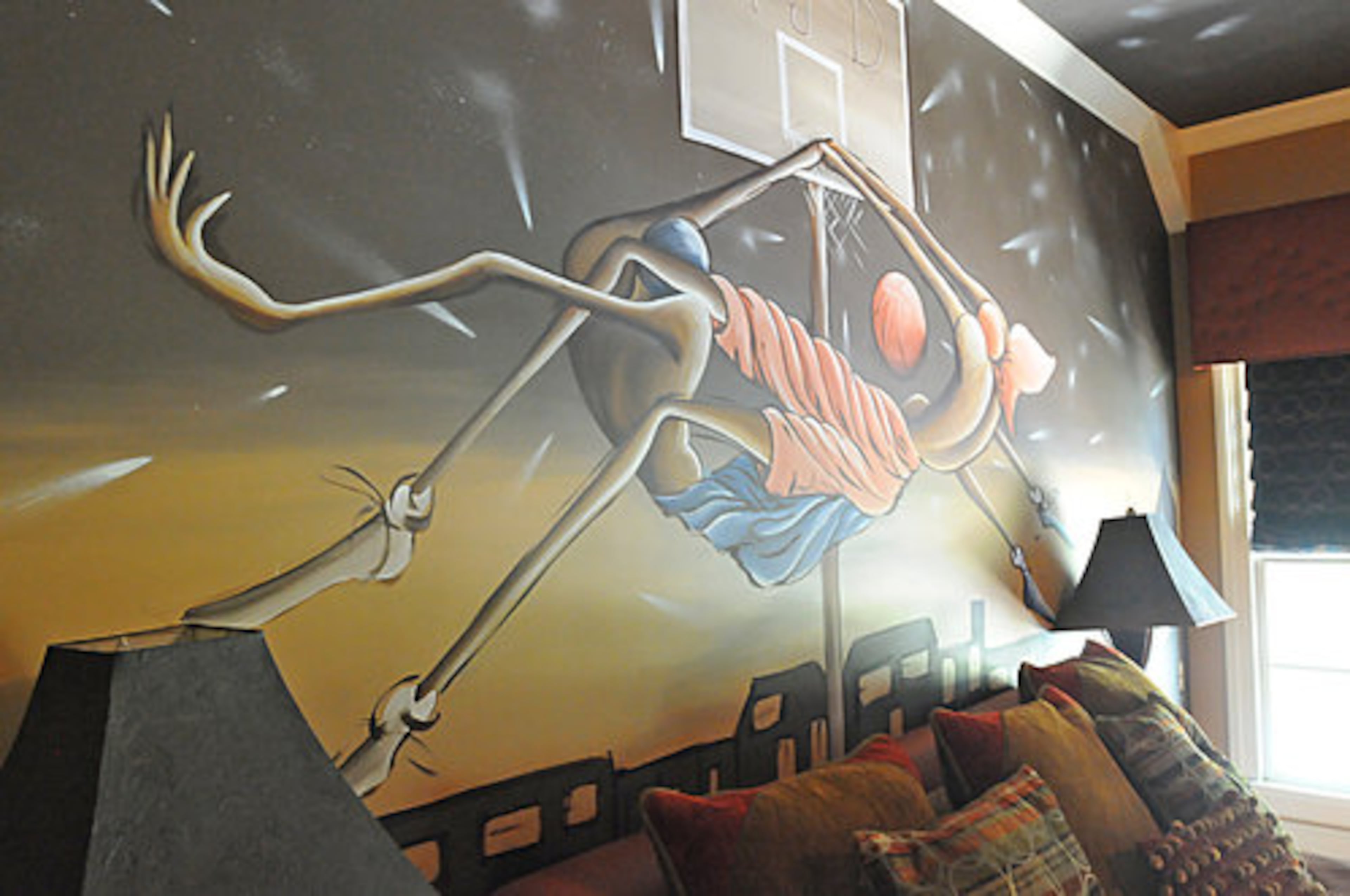 The son's room also features original artwork, this time over the bed. This room features a more masculine color scheme, and is a perfect transition from a boy's room to an adolescent's room.