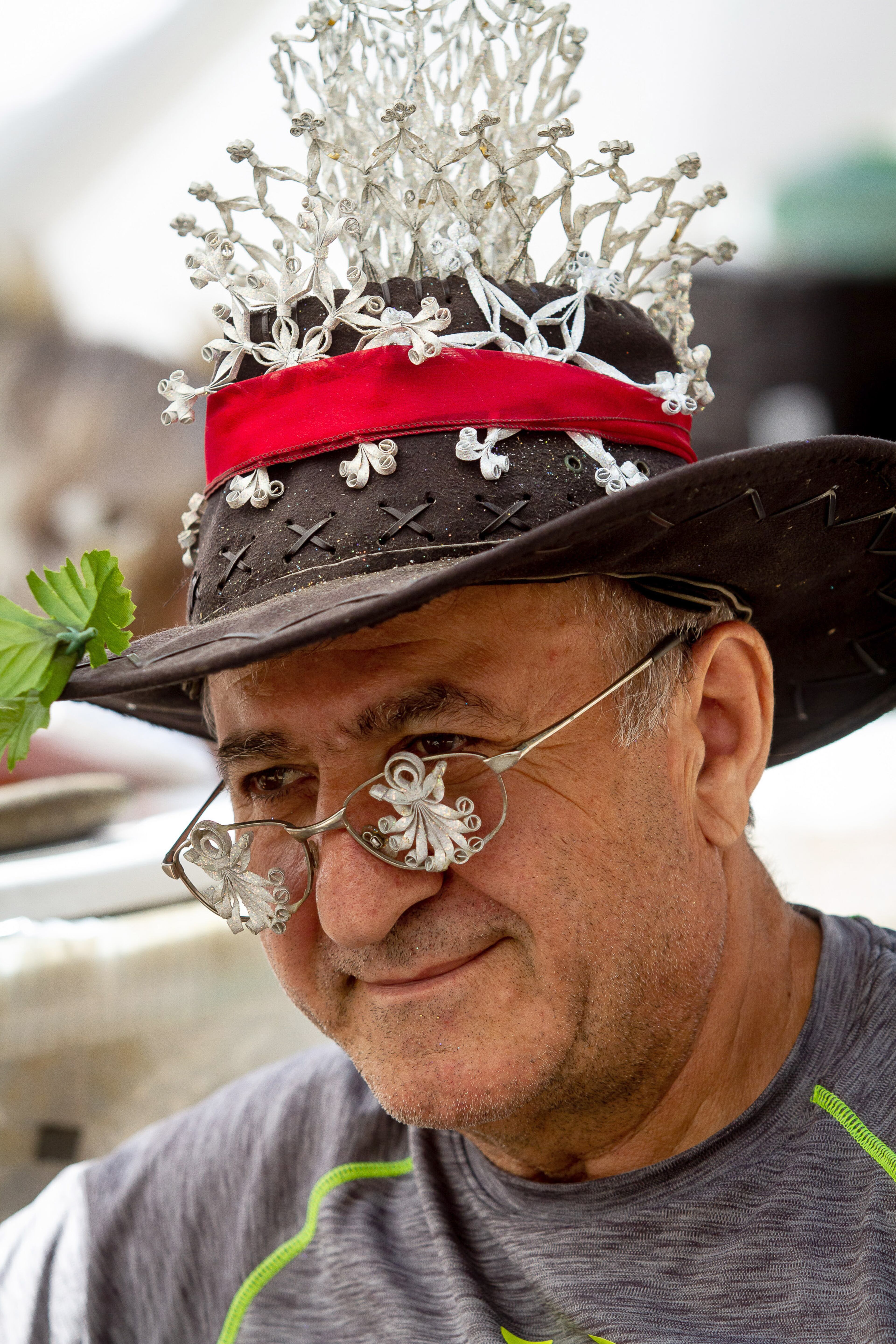 Gagik Gasparian wears some of his artwork while waiting on customers during the 51st annual Yellow Daisy Festival at Stone Mountain Park on Sunday, September 8, 2019. STEVE SCHAEFER / SPECIAL TO THE AJC