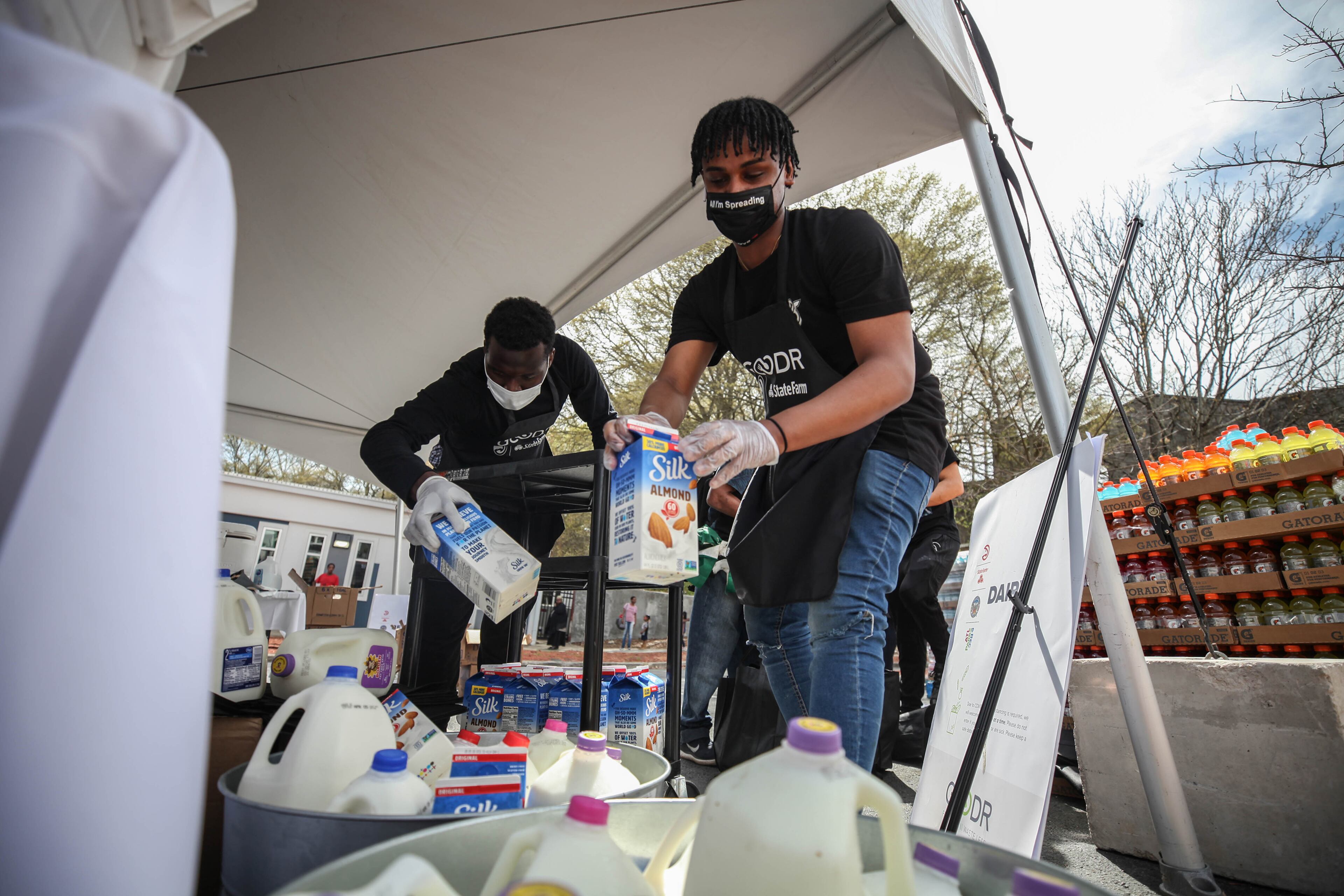 Moorehouse Senior Emanuael Golla stocks milk at the first of five pop-up grocery store locations provided by The Atlanta Hawks, Goodr, and State Farm at At-Promise Youth Center during the COVID-19 crisis, Friday, March 20, 2020. BRANDEN CAMP/SPECIAL