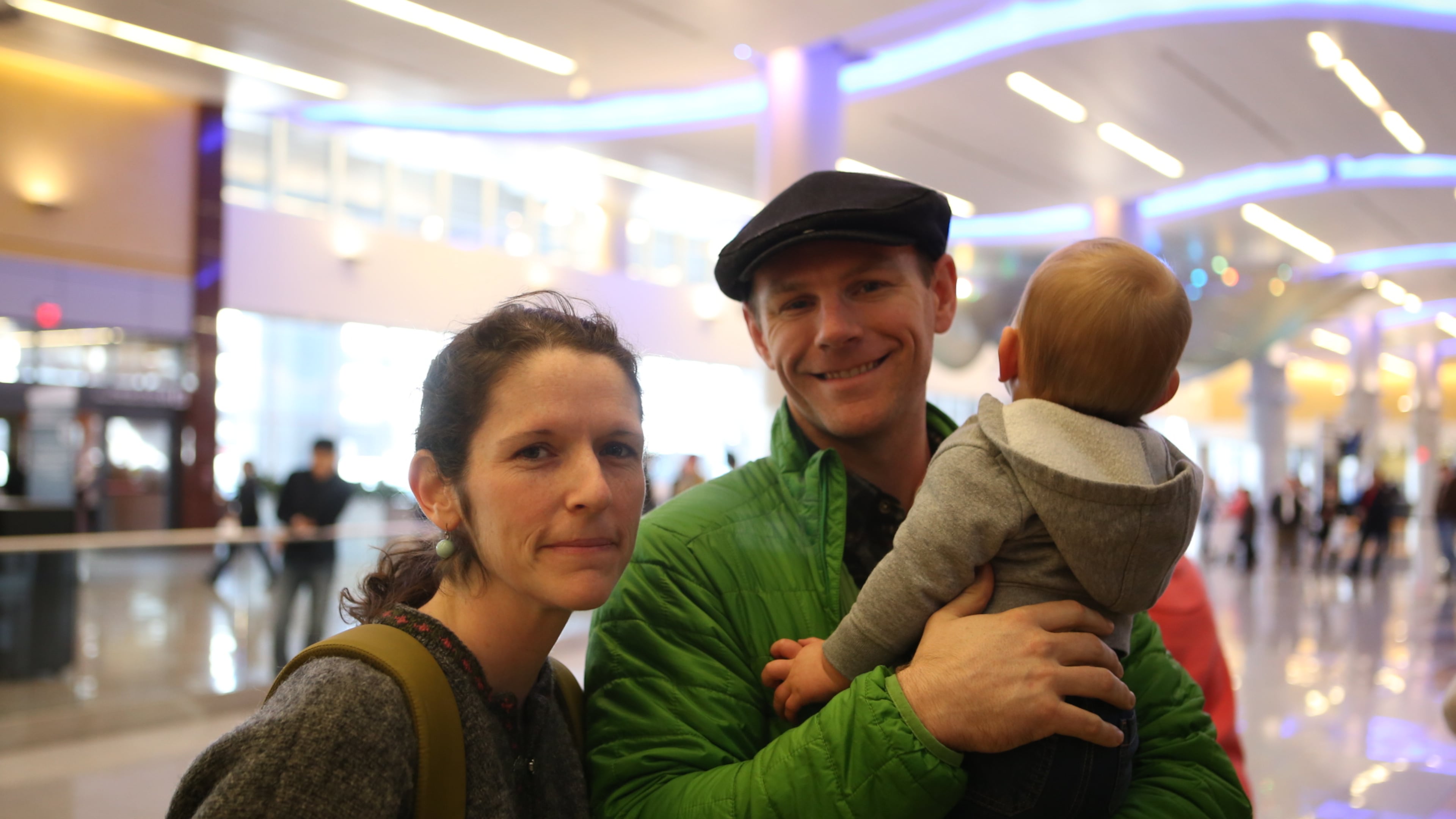 Anna and David Rau and their 14-month-old son who they did not want identified at Hartsfield-Jackson International Airport. (Photo by Henry Taylor/henry.taylor@ajc.com)