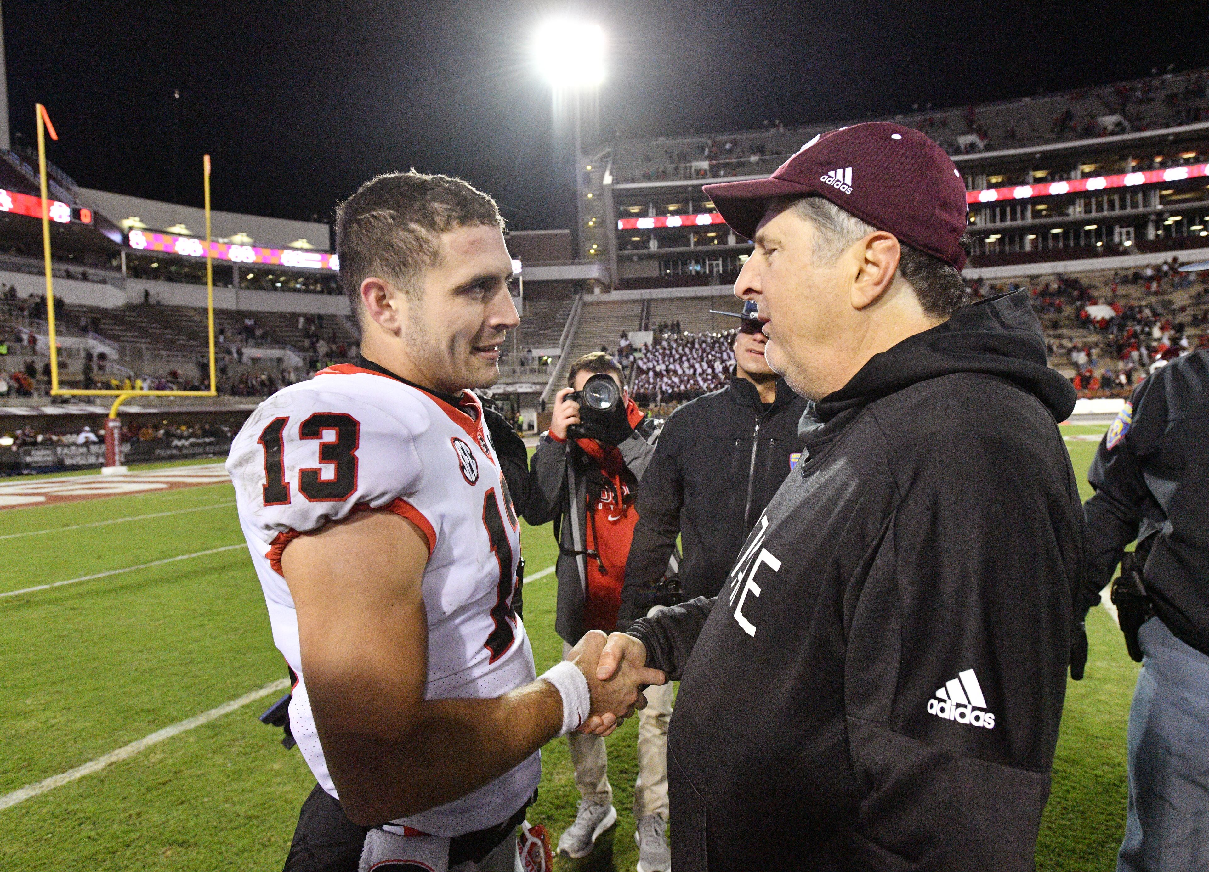 Georgia's quarterback Stetson Bennett (13) and Mississippi State's head coach Mike Leach shake hands after the game. (Hyosub Shin / Hyosub.Shin@ajc.com)