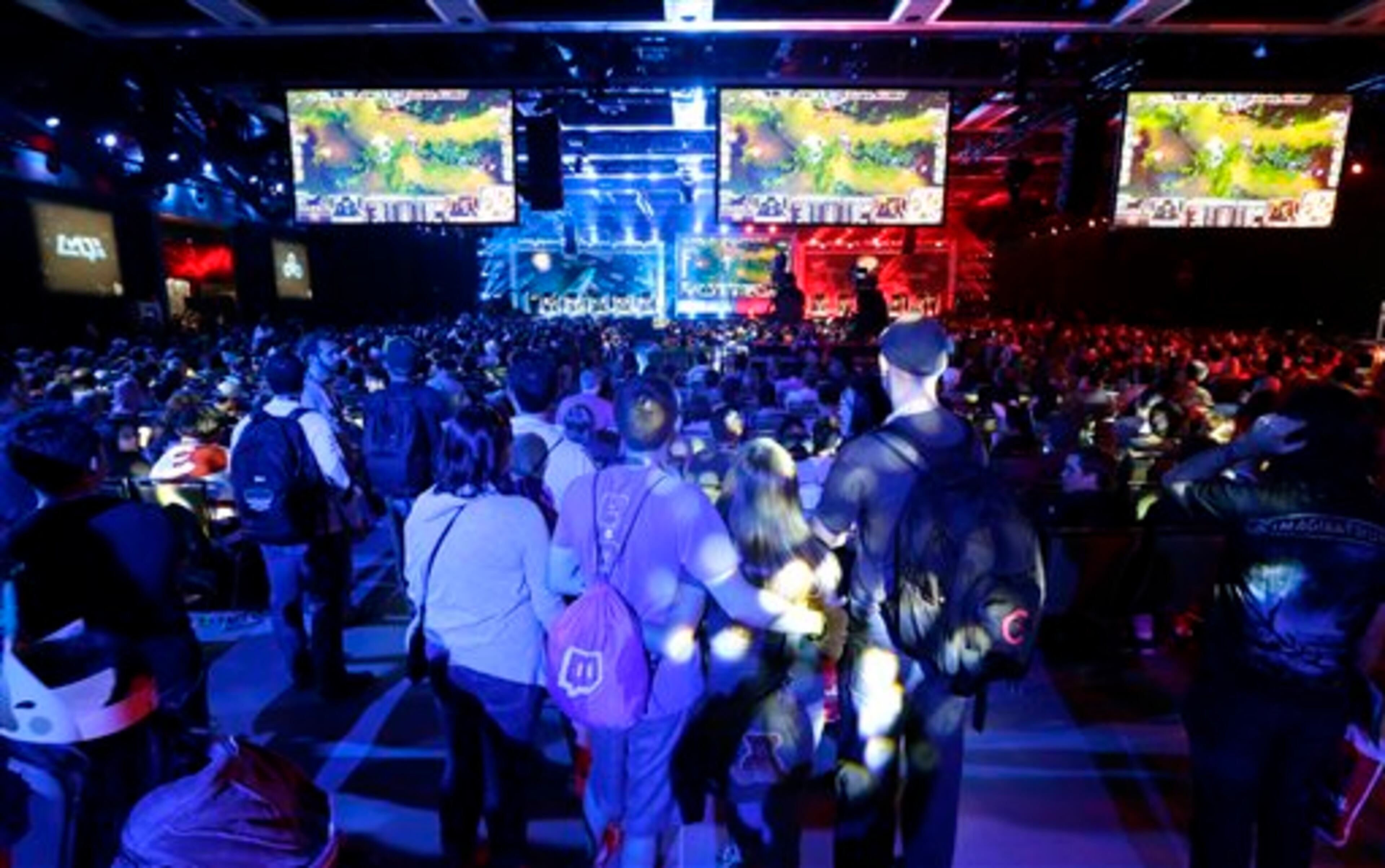 Hundreds of spectators fill an exhibition hall to watch a round of the League of Legends championship series video game competition, Friday, Aug. 29, 2014, at the Penny Arcade Expo, a fan-centric celebration of gaming in Seattle. The event is expected to be attended by roughly 85,000 gamers and will include concerts, game tournaments and previews of upcoming titles. (AP Photo/Ted S. Warren)