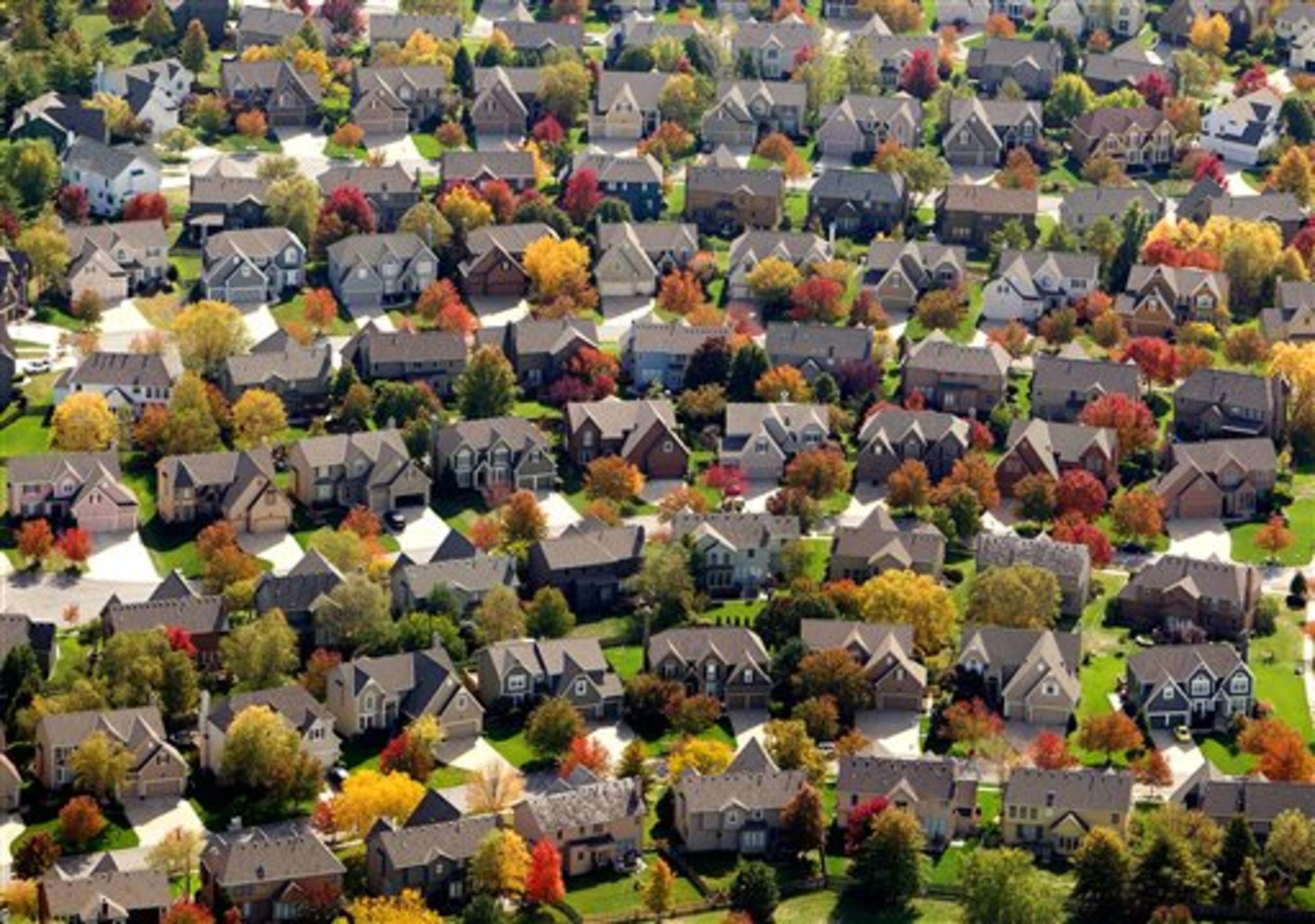 Trees with fall leaves surround homes in Overland Park, Kan., on Monday, Oct. 15, 2012. (AP Photo/The Kansas City Star, John Sleezer)