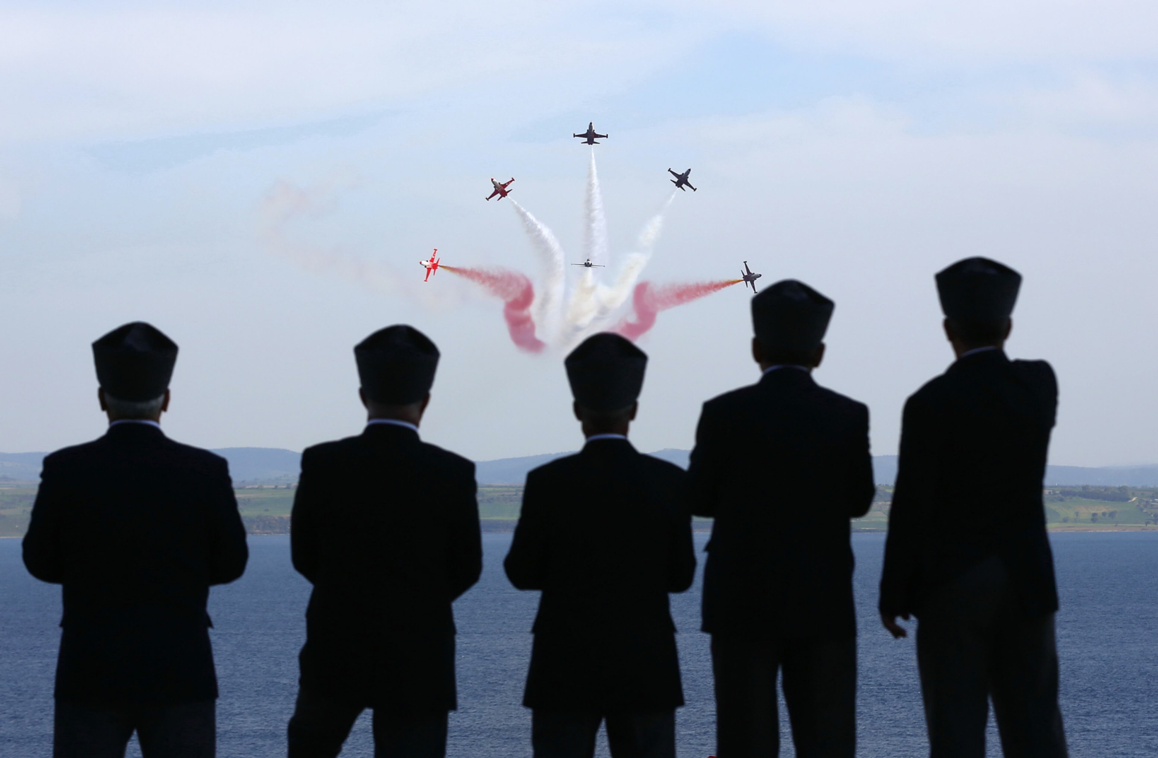 BATTLE OF GALLIPOLI COMMEMORATION--SEDDULBAHIR, TURKEY - APRIL 24: Planes fly over the Canakkale Matyrs' Memorial during a ceremony to mark the 100th anniversary of the Battle of Gallipoli, on April 24, 2015 in Seddulbahir, Turkey. Turkish and Allied powers representatives, as well as family members of those who served, are commemorating the 100th anniversary of the Gallipoli campaign with ceremonies at memorials across the Gallipoli Peninsula. The Gallipoli land campaign, in which a combined Allied force of British, French, Australian, New Zealand and Indian troops sought to occupy the Gallipoli Peninsula and the strategic Dardanelles Strait during World War I, began on April 25, 1915 against Turkish forces of the Ottoman Empire. The Allies, unable to advance more than a few kilometers, withdrew after eight months. The campaign cost the Allies approximately 50,000 killed and up to 200,000 wounded, the Ottomans approximately 85,000 killed and 160,000 wounded. (Photo by Ercan Arslan/Getty Images) *** BESTPIX ***