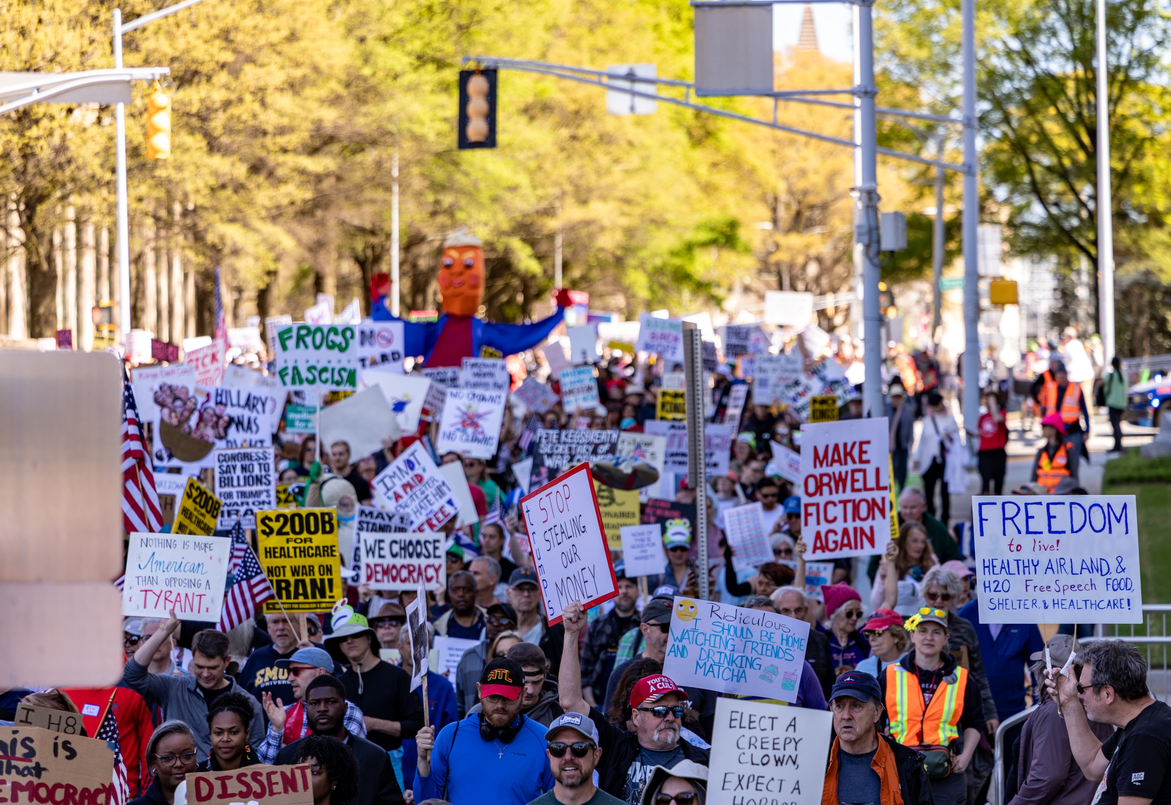 Demonstrators march toward the state Capitol during the No Kings protest on Saturday, March 28, 2026, in Atlanta. (Jenni Girtman for the AJC)
