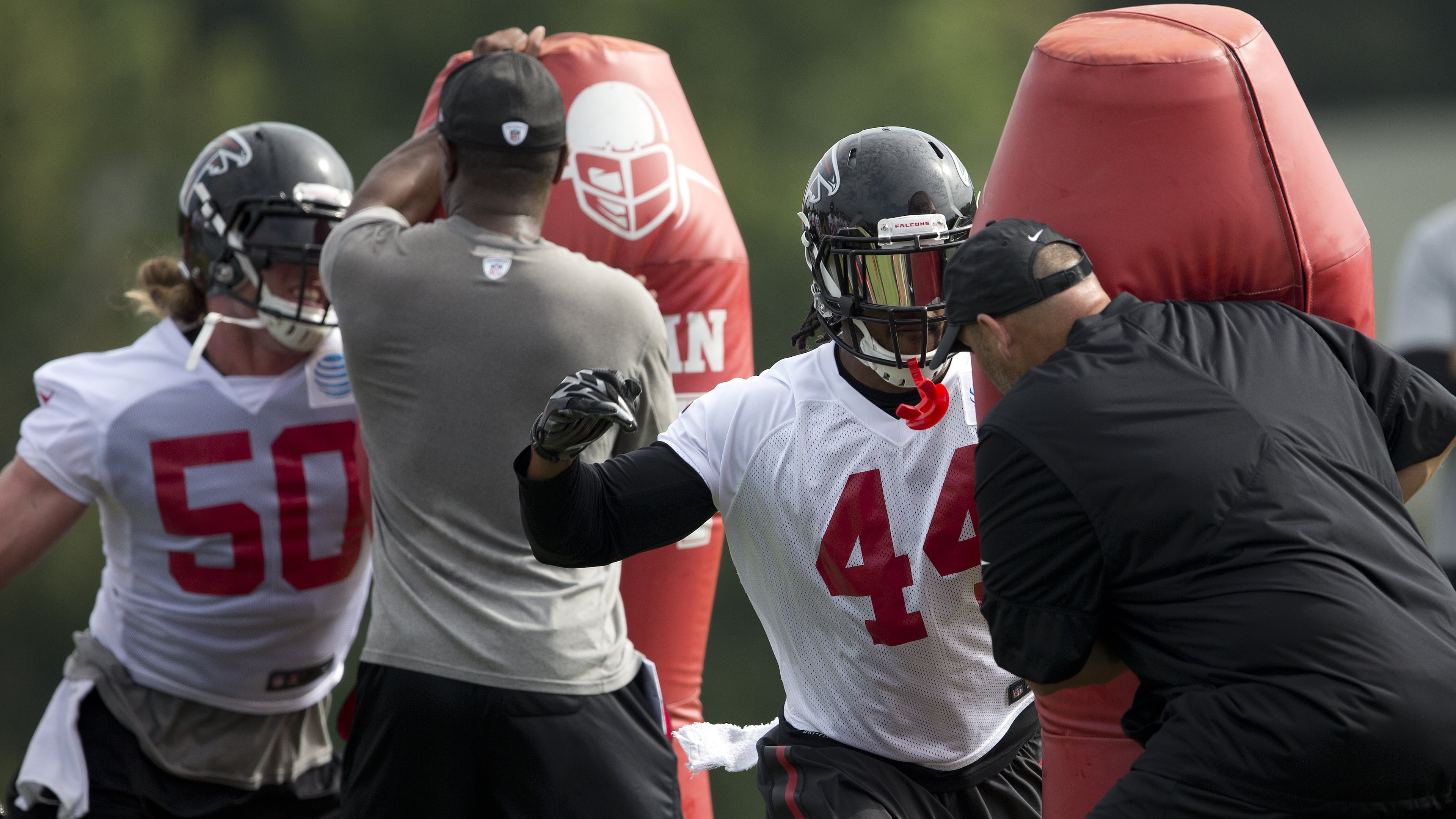 Atlanta Falcons outside linebacker Vic Beasley (44) and defensive end Brooks Reed (50) run pass rushing drills during the team's NFL training camp football practice Friday, July 28, 2017, in Flowery Branch, Ga. (AP Photo/John Bazemore)