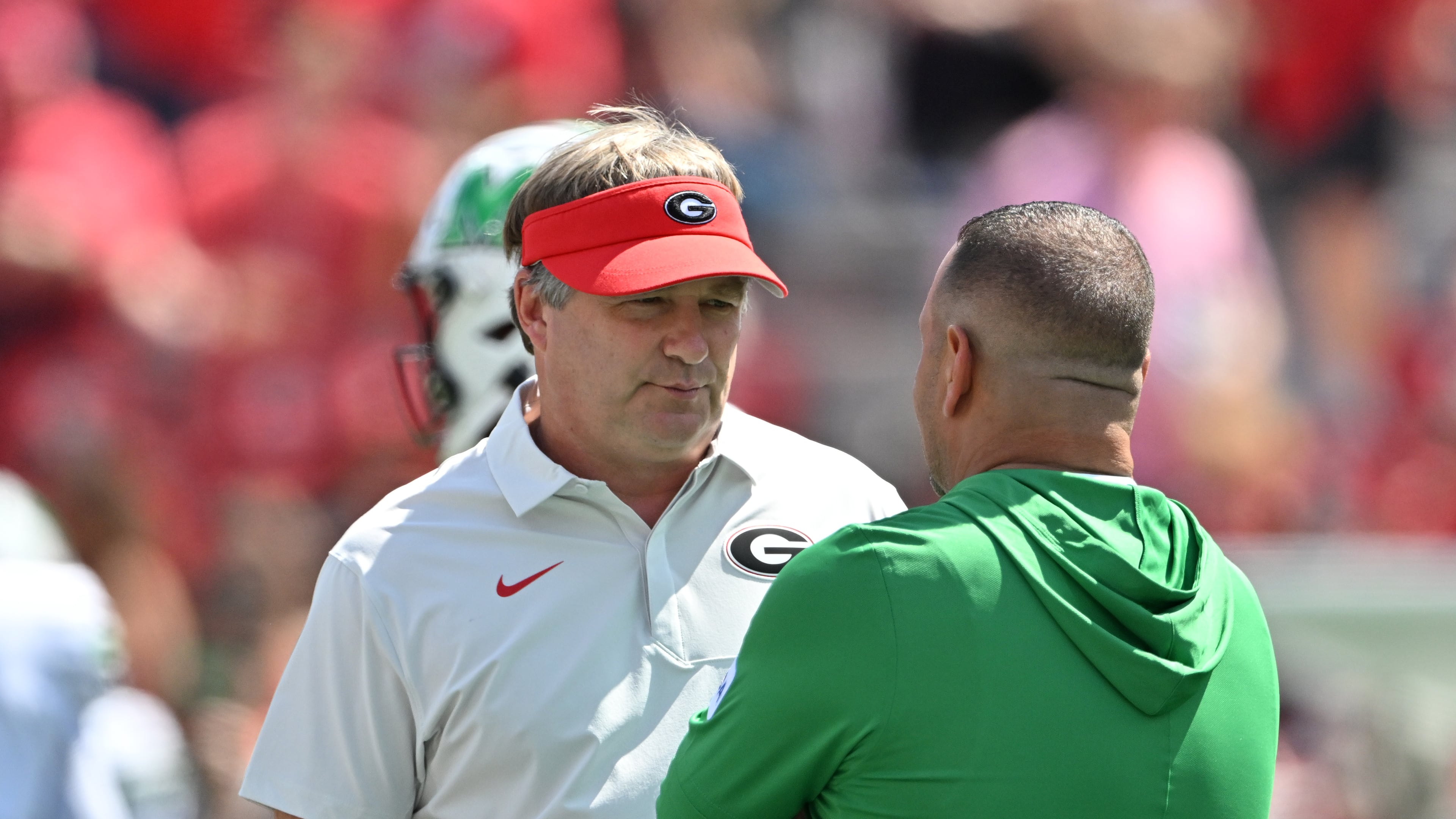 Georgia head coach Kirby Smart (left) speaks with Marshall head coach Tony Gibson at Sanford Stadium on Saturday, Aug. 30, 2025, in Athens. Smart was not happy with the level of competition Marshall provided in last season’s opening game. (Hyosub Shin/AJC)