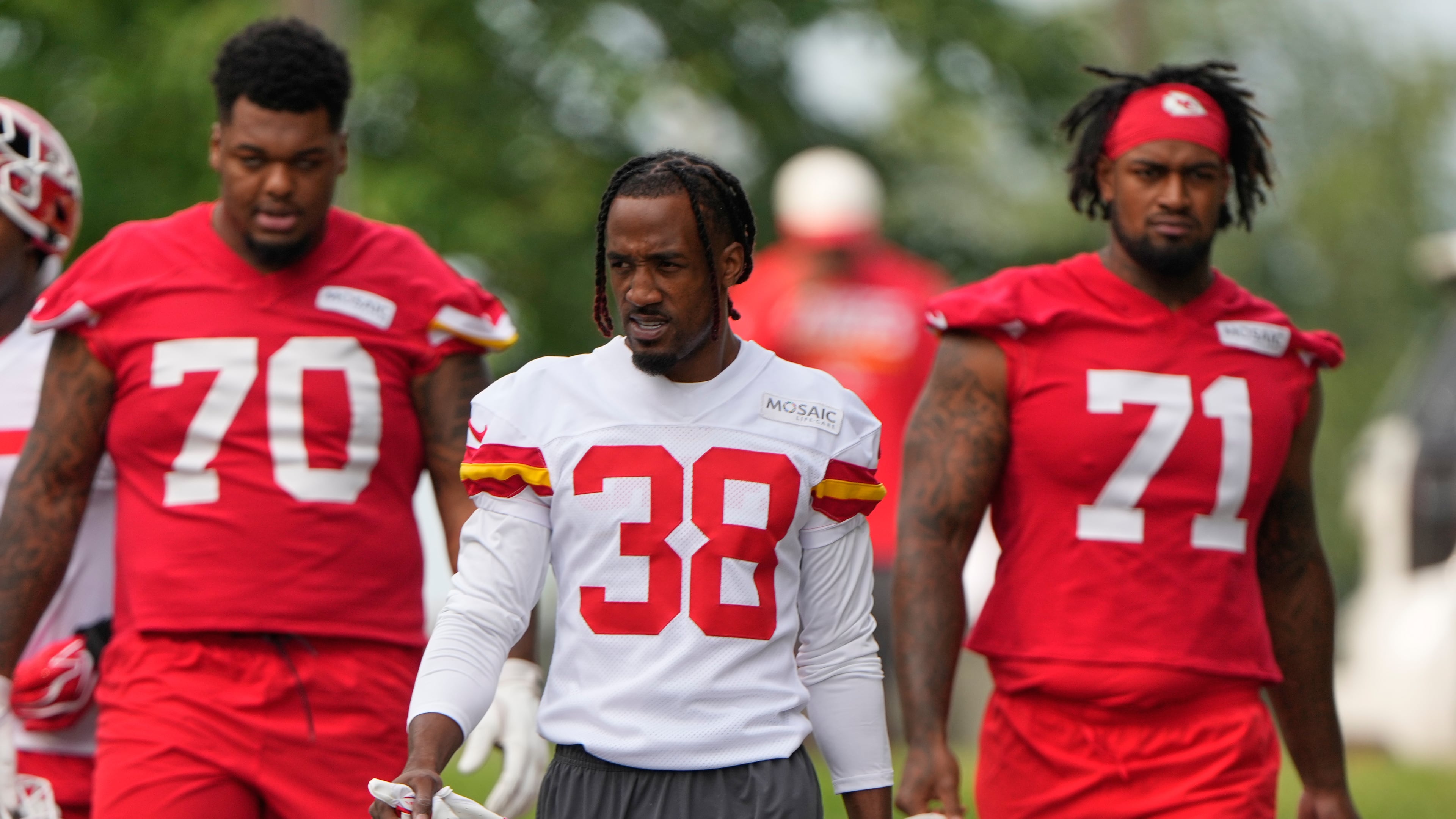 Kansas City Chiefs tackle Kahil Benson (70), cornerback L'Jarius Sneed (38) and tackle Josh Simmons (71) arrive at NFL football training camp Wednesday, July 29, 2026, in St. Joseph, Mo. (AP Photo/Charlie Riedel)