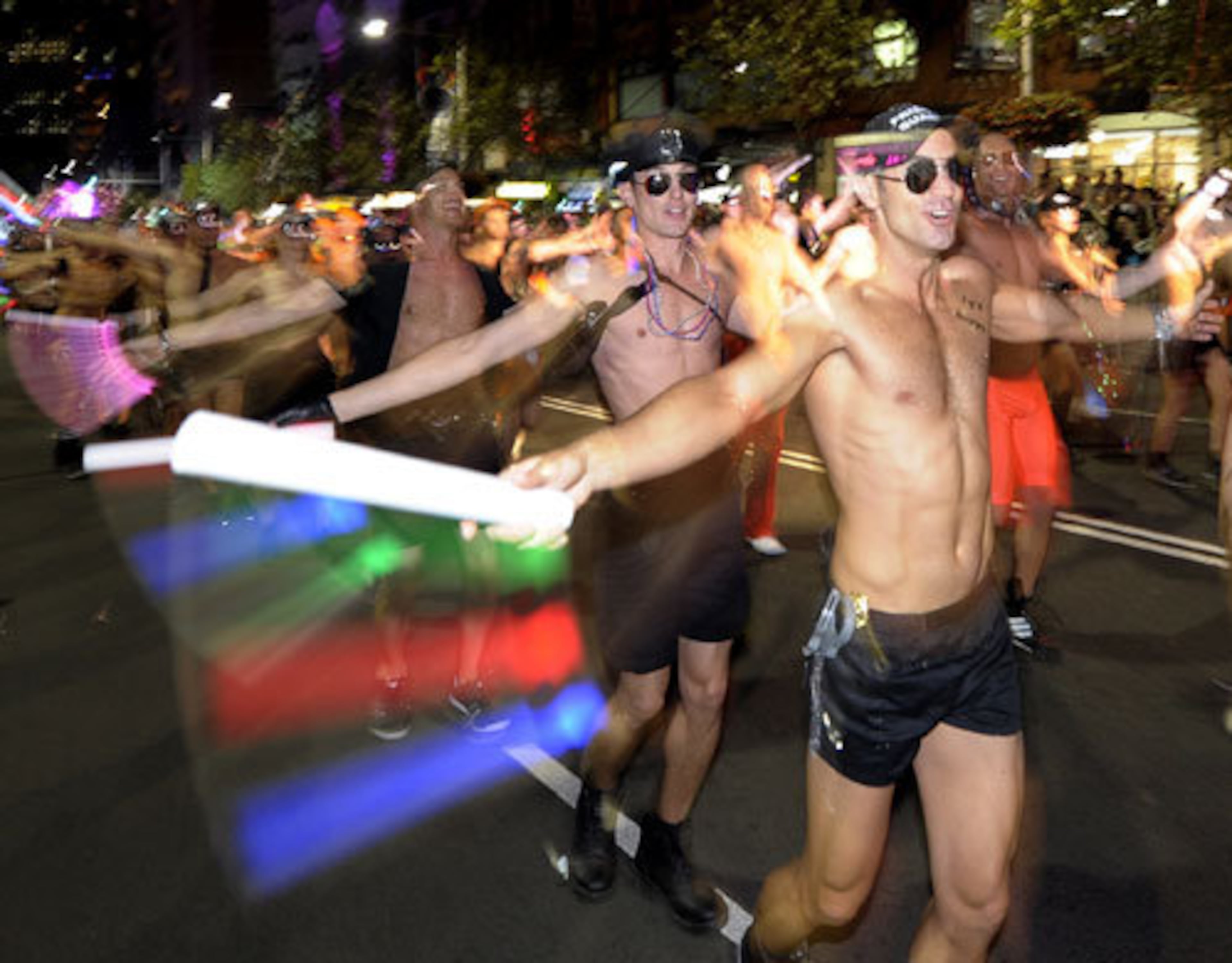 People perform during a parade as part of Gay and Lesbian Mardi Gras.