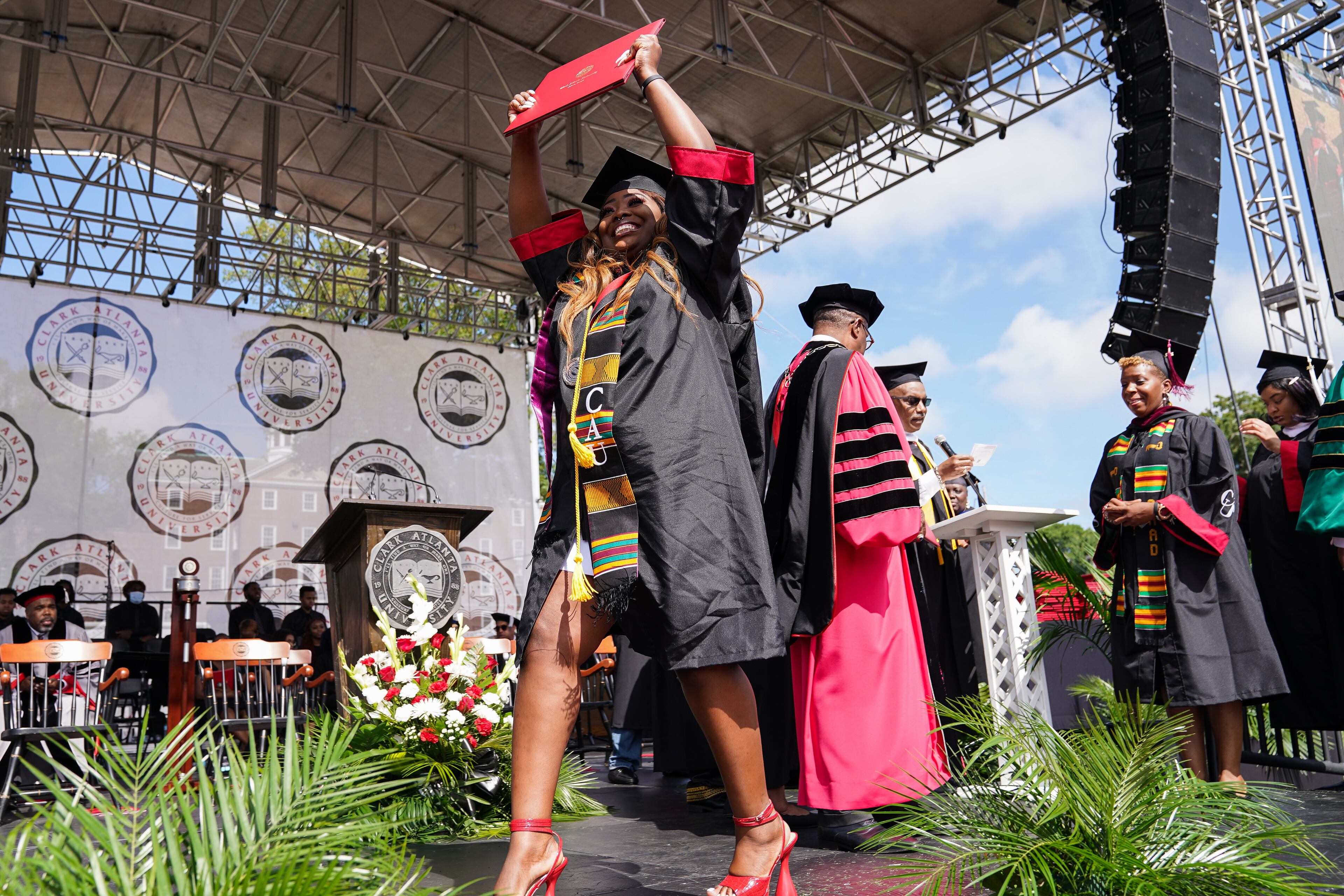 A student celebrates as she receives her degree during Clark Atlanta University’s 33rd Commencement Exercises, at Panther Stadium on Saturday, May 14, 2022, in Atlanta. (Elijah Nouvelage for The Atlanta Journal-Constitution)