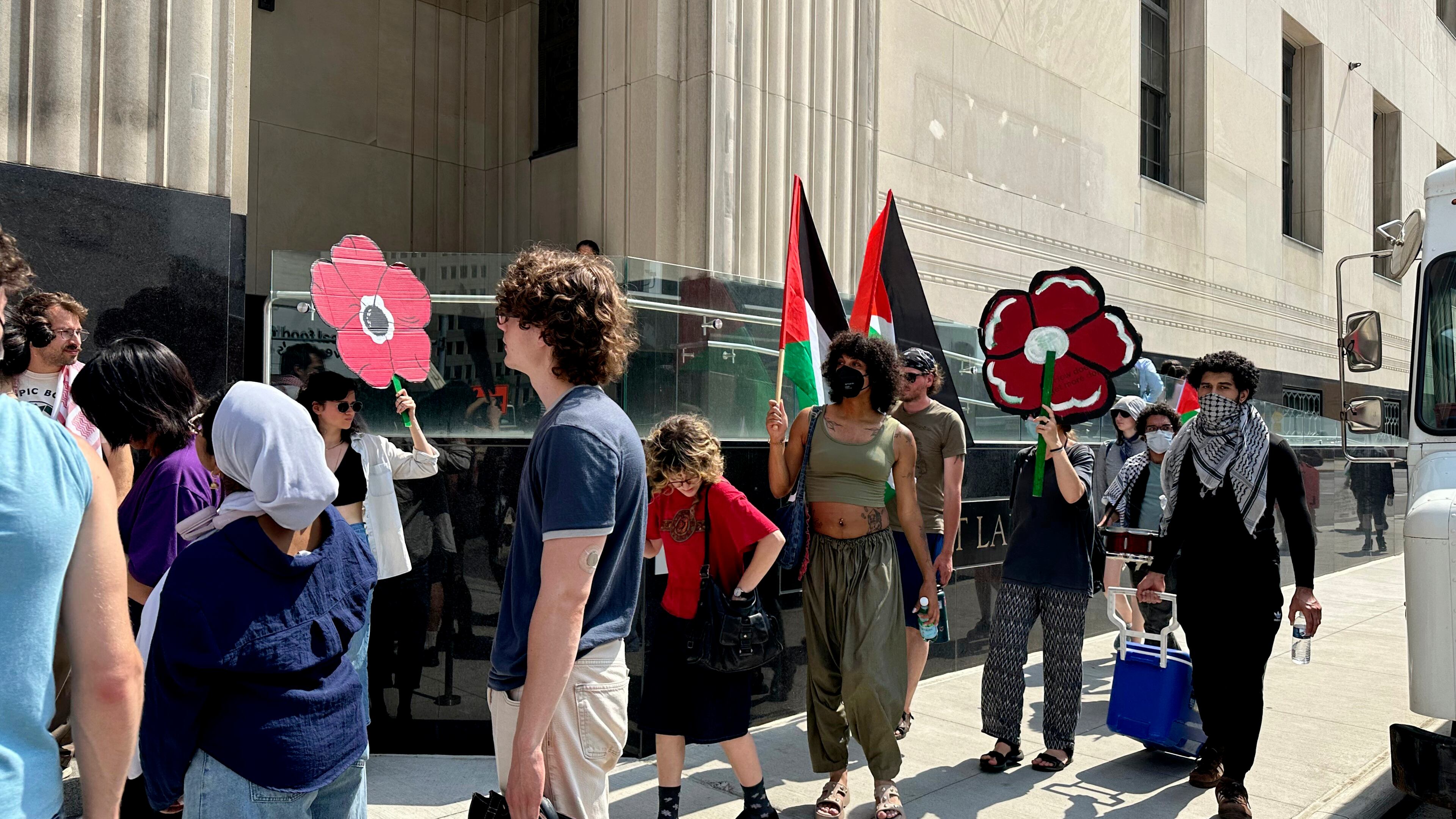 People carry Palestinian flags outside the federal courthouse in Detroit on Wednesday, June 10, 2026, after activists appeared in court on conspiracy charges. (AP Photo/Ed White)