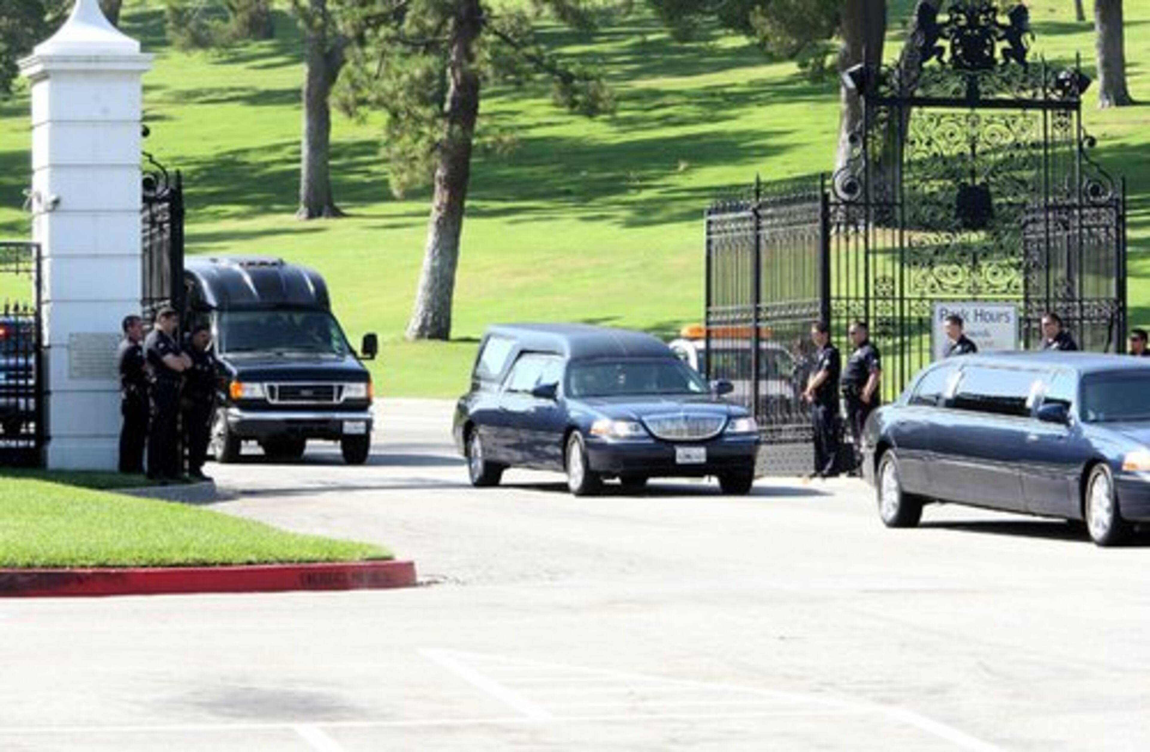The hearse presumably moving Michael Jackson leaves Forest Lawn Memorial Park.
