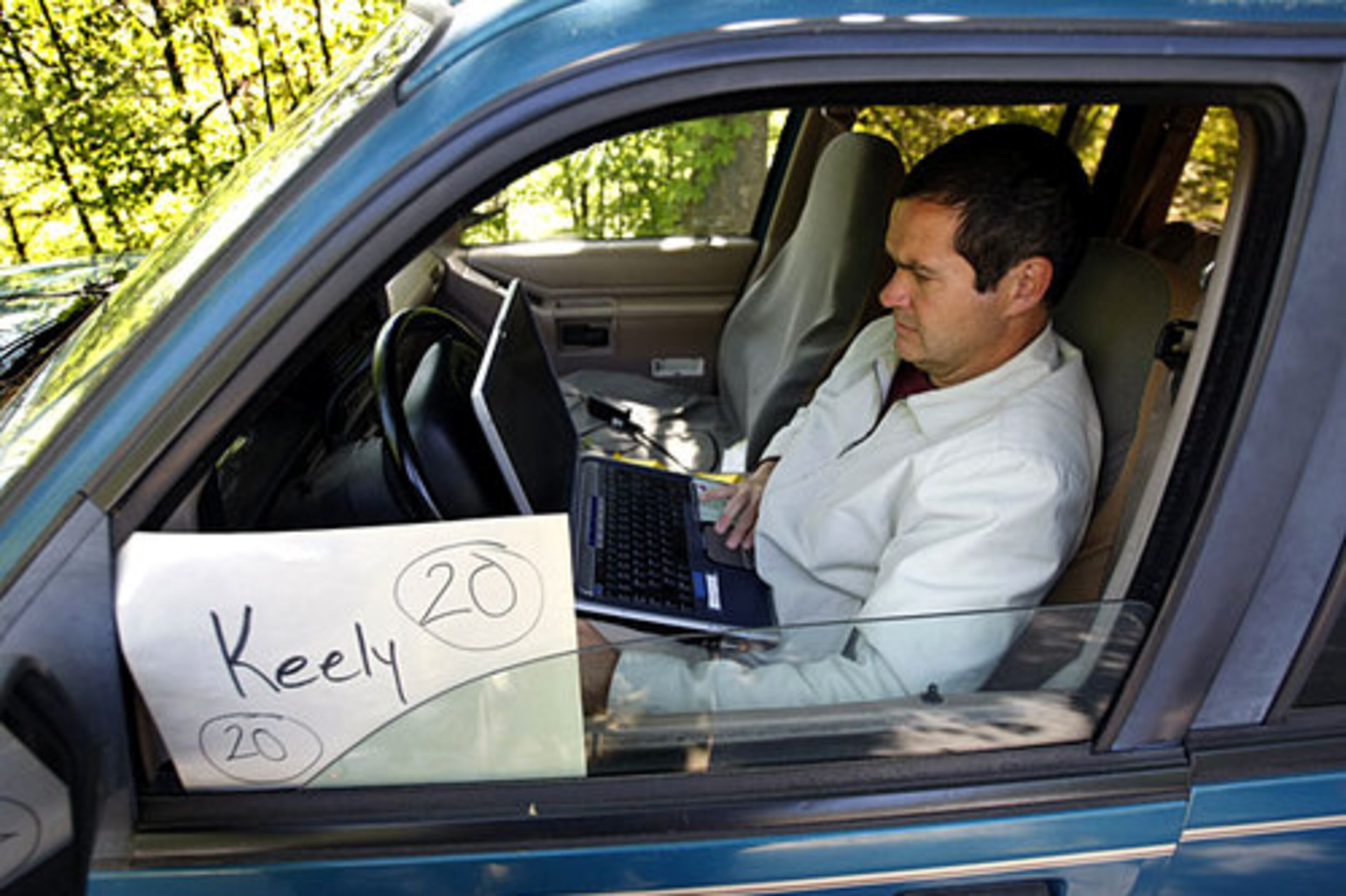 The camp-out at Mary Lin Elementary has become an annual tradition. The quiet street resembled a camping ground with lines of RVs, grills, mess tents and picnic chairs. Some parents sat outside typing on laptop computers and returning work phone calls. Many parents used vacation and sick days to take time off from work to wait. Boyd Baker works on his laptop after showing up at 7:20 a.m. Monday. He was doing it for his daughter, Keely Baker.