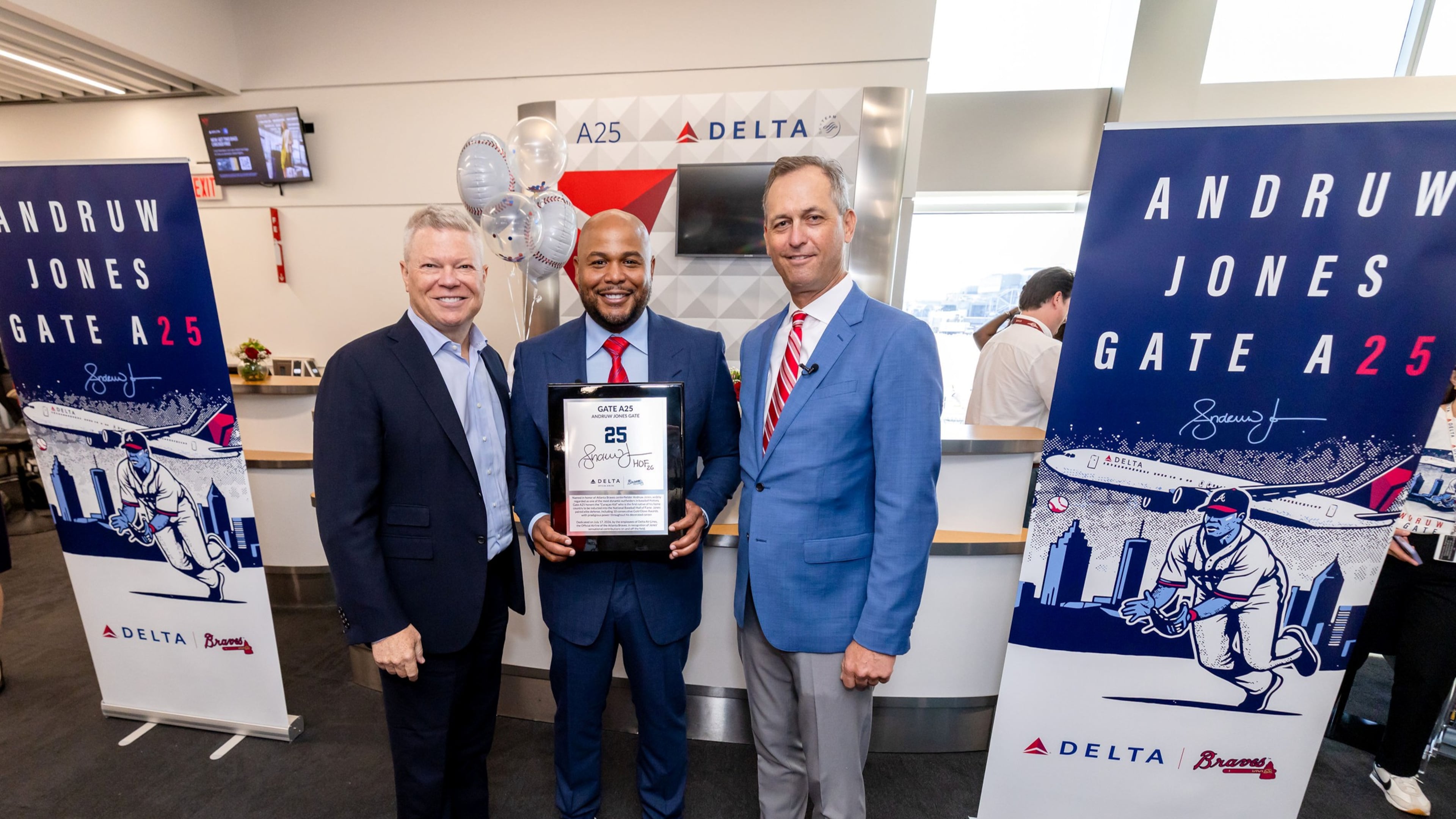 Delta senior vice president and chief communications officer Tim Mapes (left), former Braves center fielder Andruw Jones (center), and Braves president and CEO Derek Schiller (right) were part of a dedication ceremony Friday at Hartsfield-Jackson Atlanta International Airport. (Courtesy of Delta)