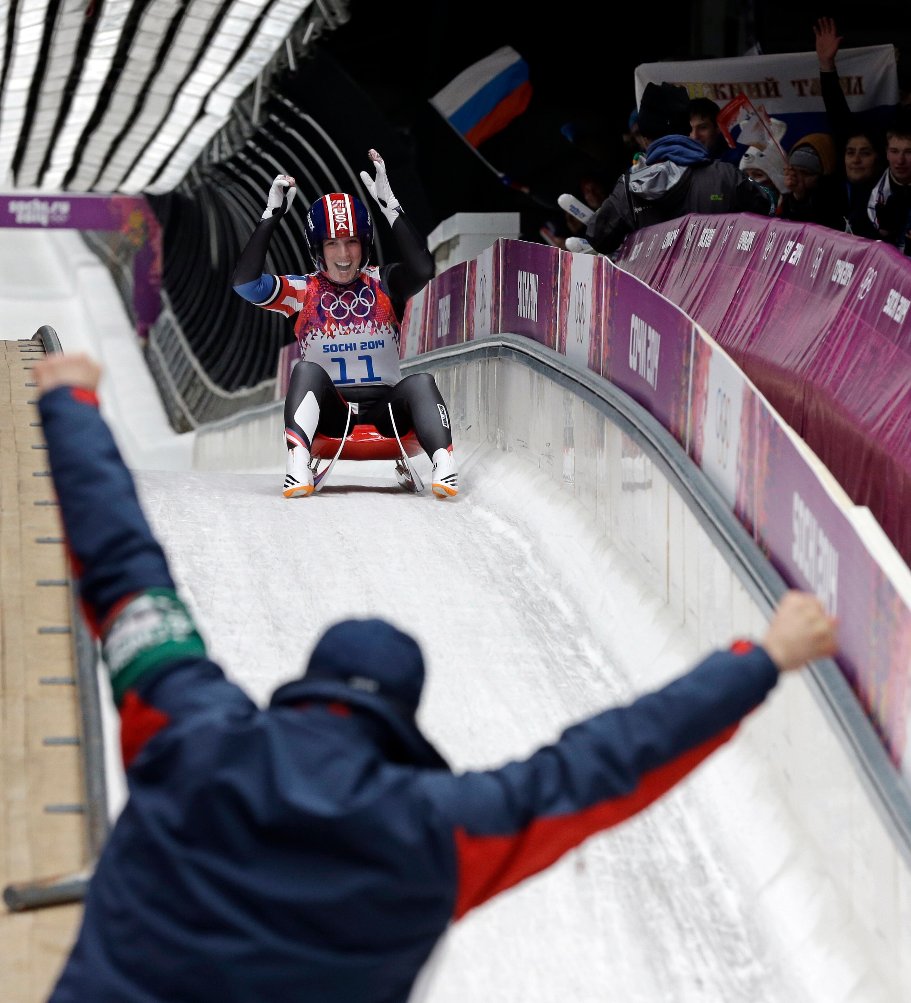 Erin Hamlin of the United States greets her coach after finishing her final run to win the bronze medalduring the women's singles luge competition at the 2014 Winter Olympics, Tuesday, Feb. 11, 2014, in Krasnaya Polyana, Russia. (AP Photo/David J. Phillip )