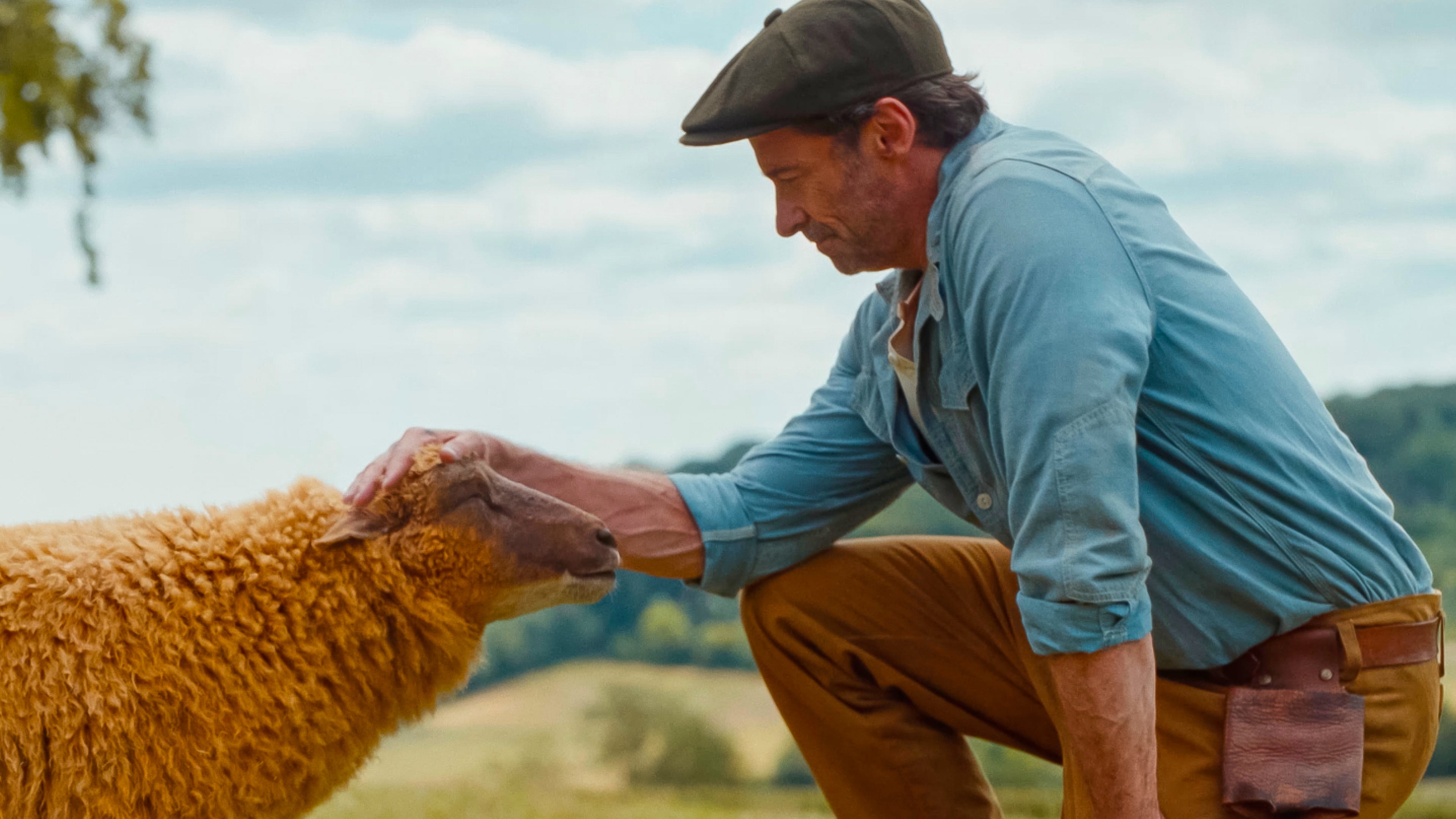 This image released by Amazon MGM Studios shows sheep character Lily, voiced Julia-Louis Dreyfus, left, with Hugh Jackman as George Hardy, in a scene from "The Sheep Detectives." (Amazon MGM Studios via AP)
