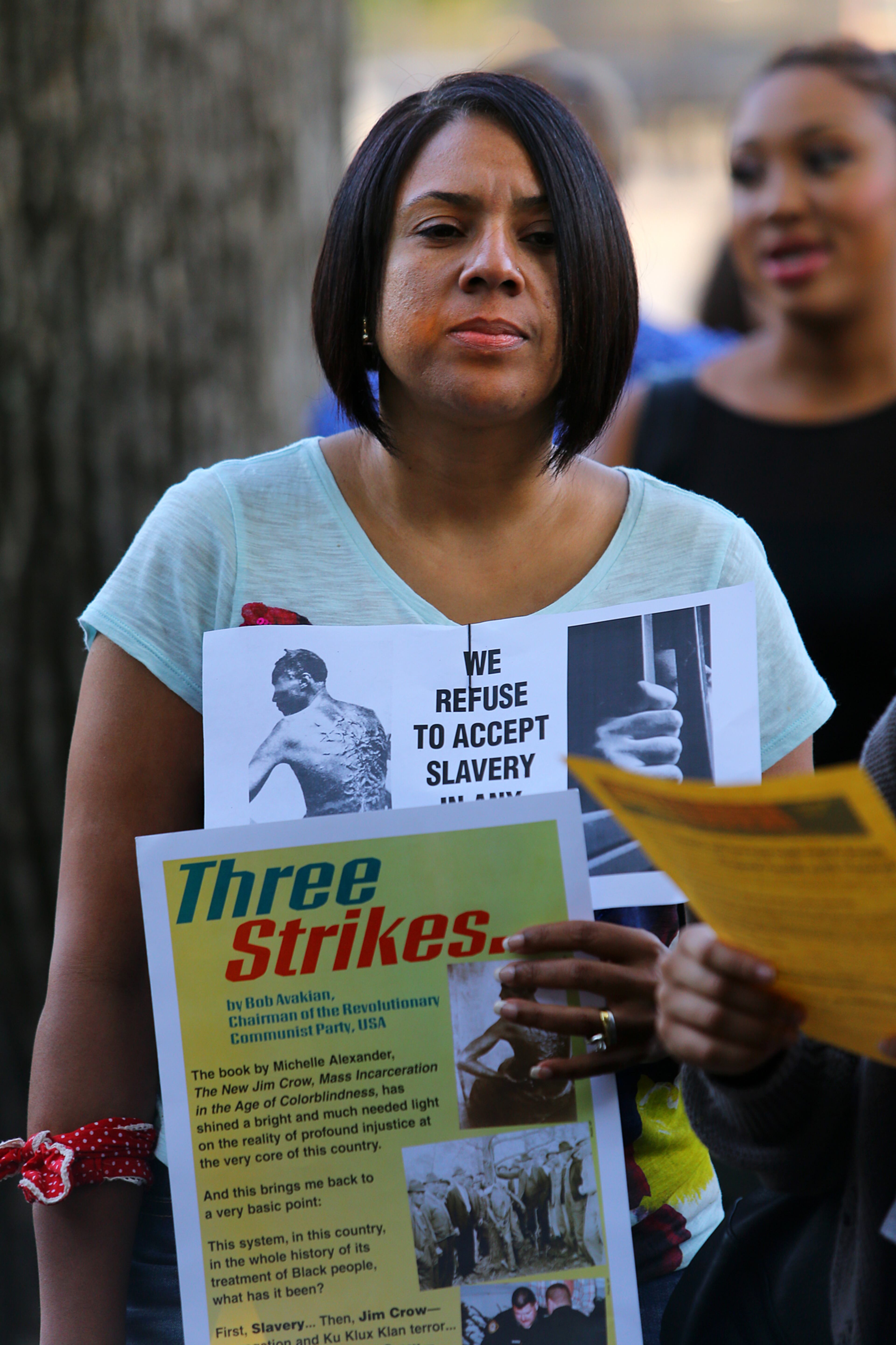 Tracy Cannon, Duluth, joins in a candlelight vigil and moment of silence protesting the police shooting of Michael Brown as part of a national observance on Thursday, Aug. 14, 2014, in Decatur. CURTIS COMPTON / CCOMPTON@AJC.COM