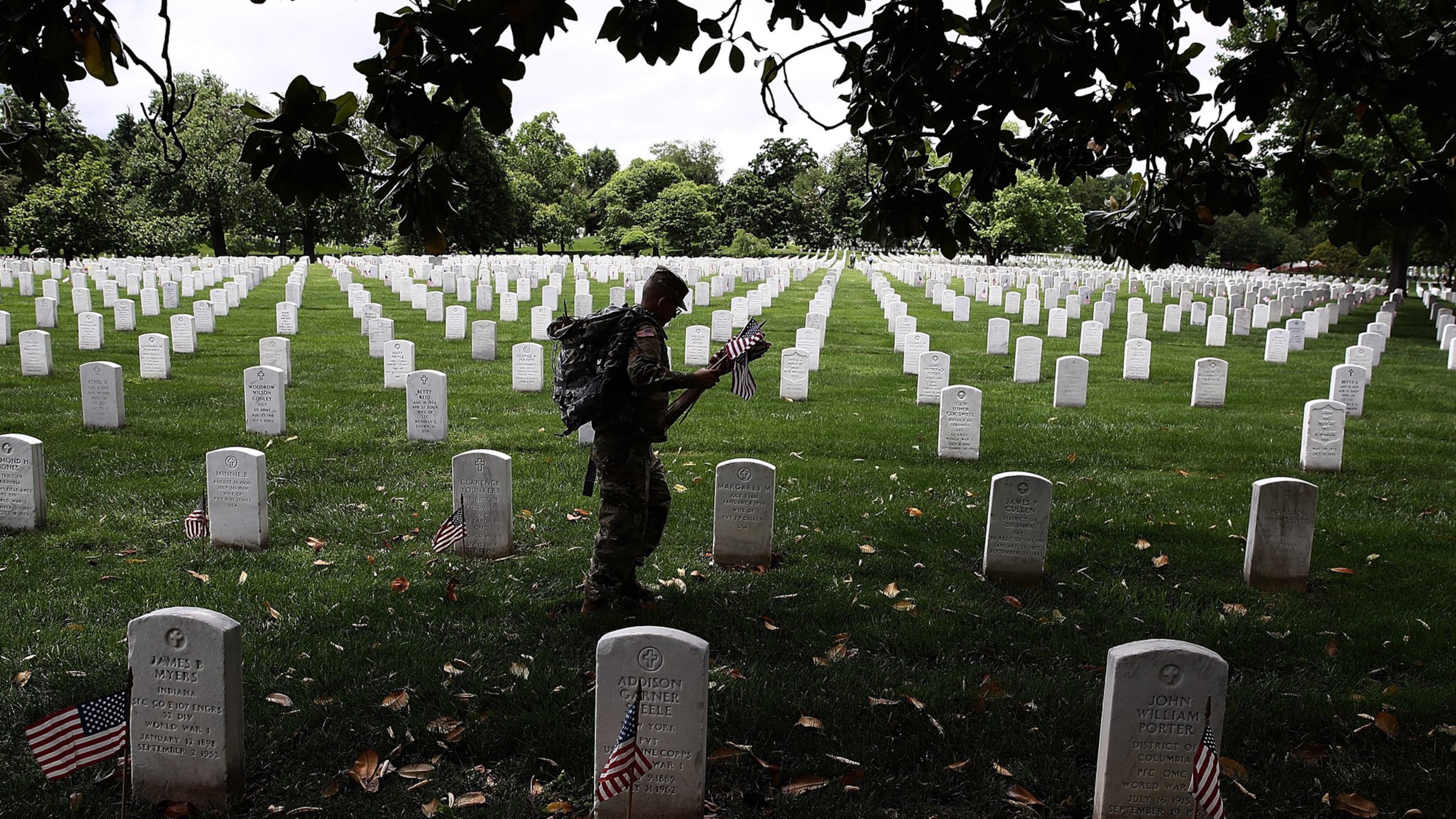 ARLINGTON, VA: Members of the U.S. Army’s 3rd Infantry Regiment place flags at the headstones of U.S. military personnel buried at Arlington National Cemetery, in preparation for Memorial Day in Arlington, Virginia. (Photo by Win McNamee/Getty Images)
