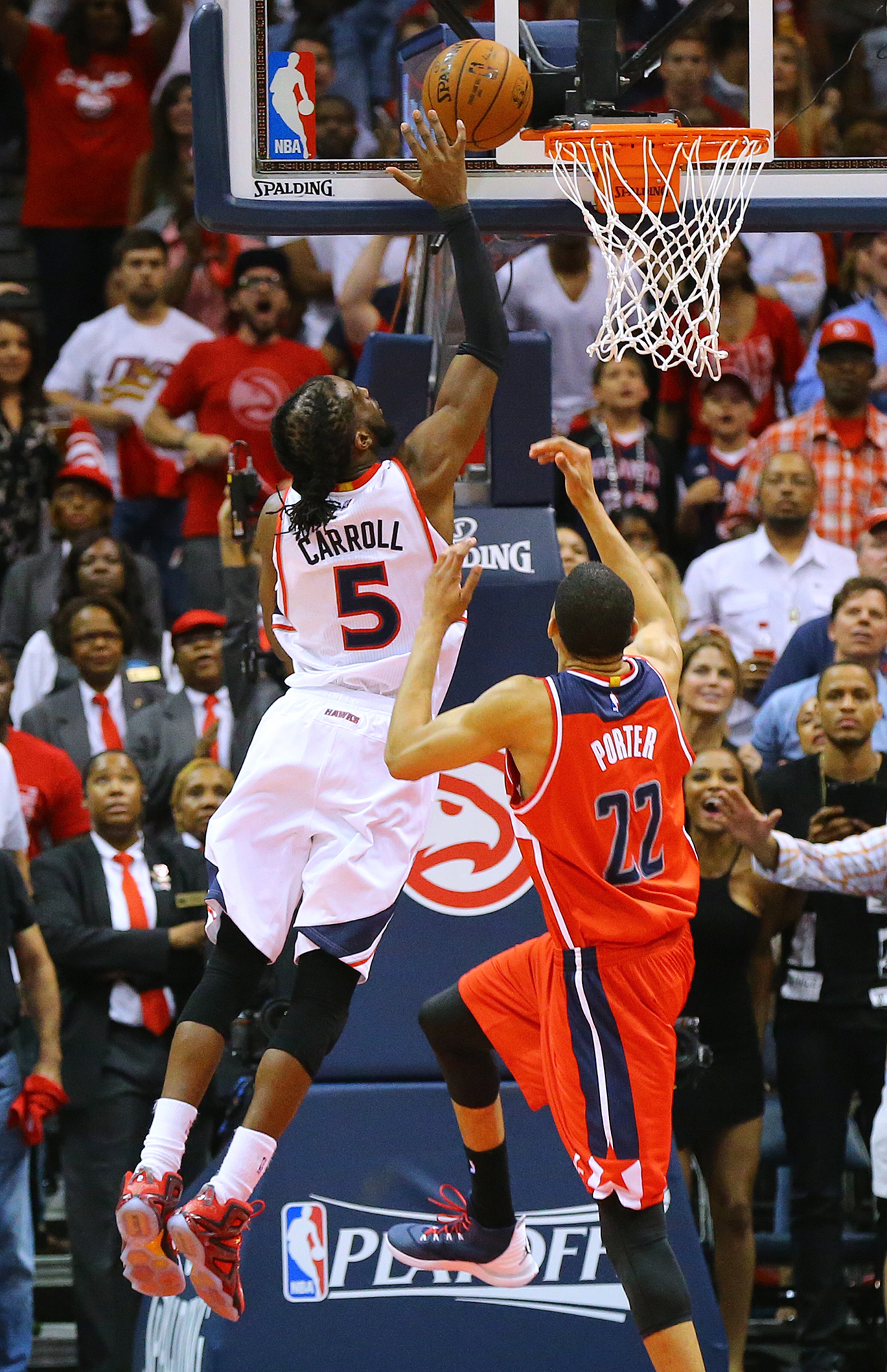 Hawks DeMarre Carroll goes to the basket for two points over Wizards Otto Porter for a 80-78 lead with 14.9 seconds left on the game clock on the way to winning the game 82-81 in their Eastern Conference Semifinals game 5 on Tuesday, May 13, 2015, in Atlanta. Curtis Compton / ccompton@ajc.com