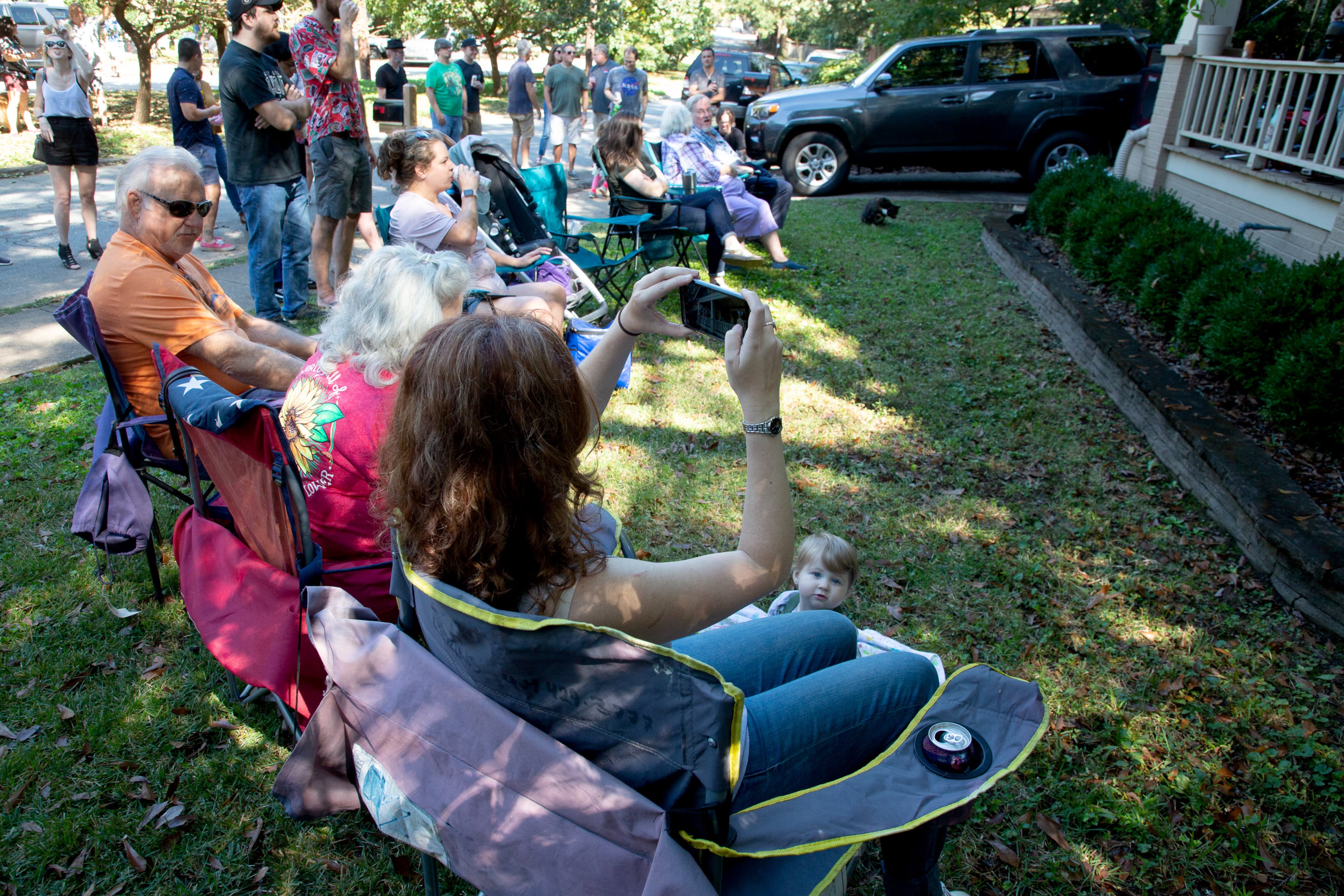 People listen to Lion and Company play during Oakhurst Porchfest in the Decatur neighborhood on Saturday, October 8, 2021. About 200 bands participate on porches and front lawns, and thousands of people attend. (Photo: Steve Schaefer for The Atlanta Journal-Constitution)