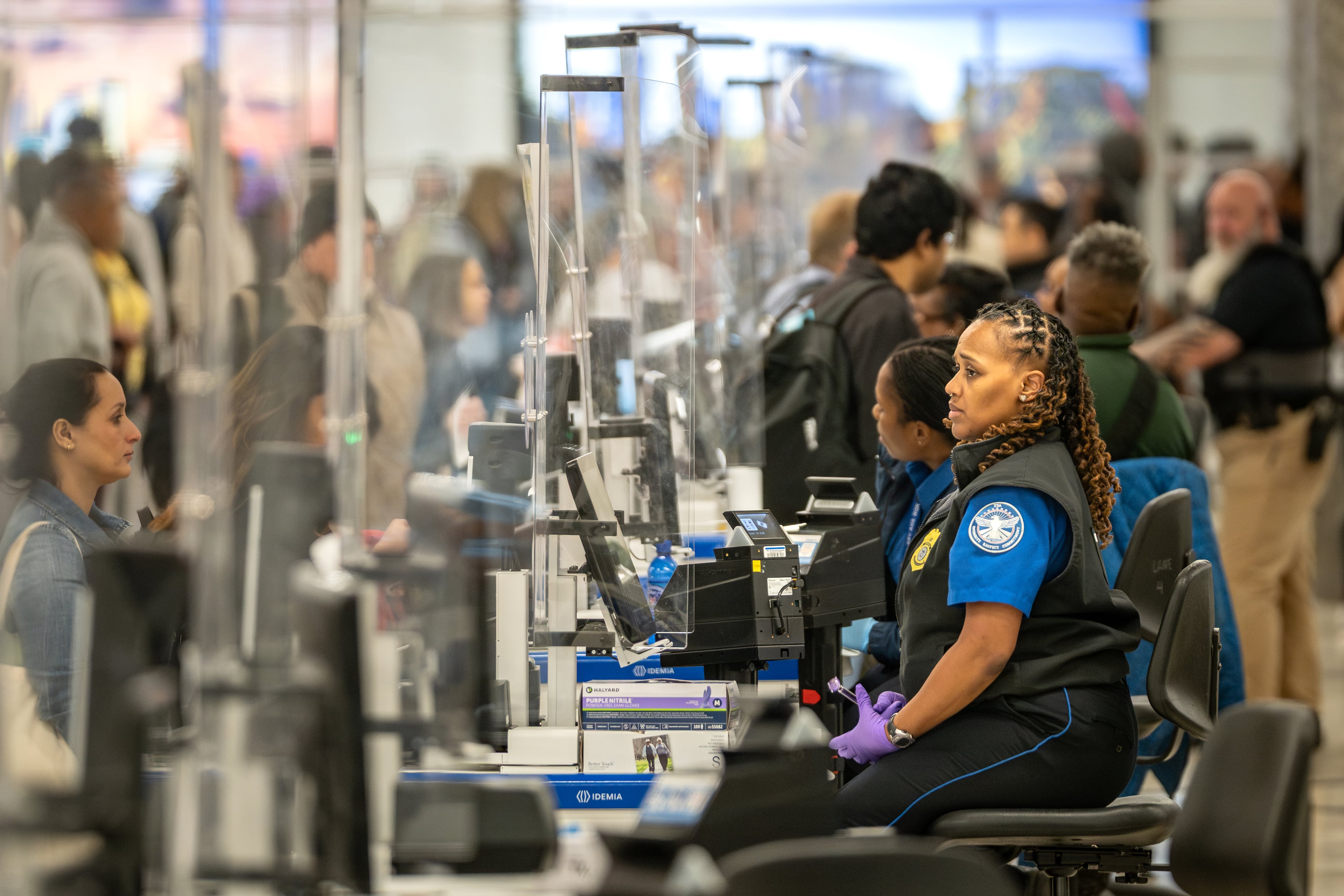 A Transportation Security Administration officer works to process long lines of travelers at Hartsfield-Jackson Atlanta International Airport amid the partial government shutdown Thursday, March 19, 2026. (Ben Hendren for the AJC)