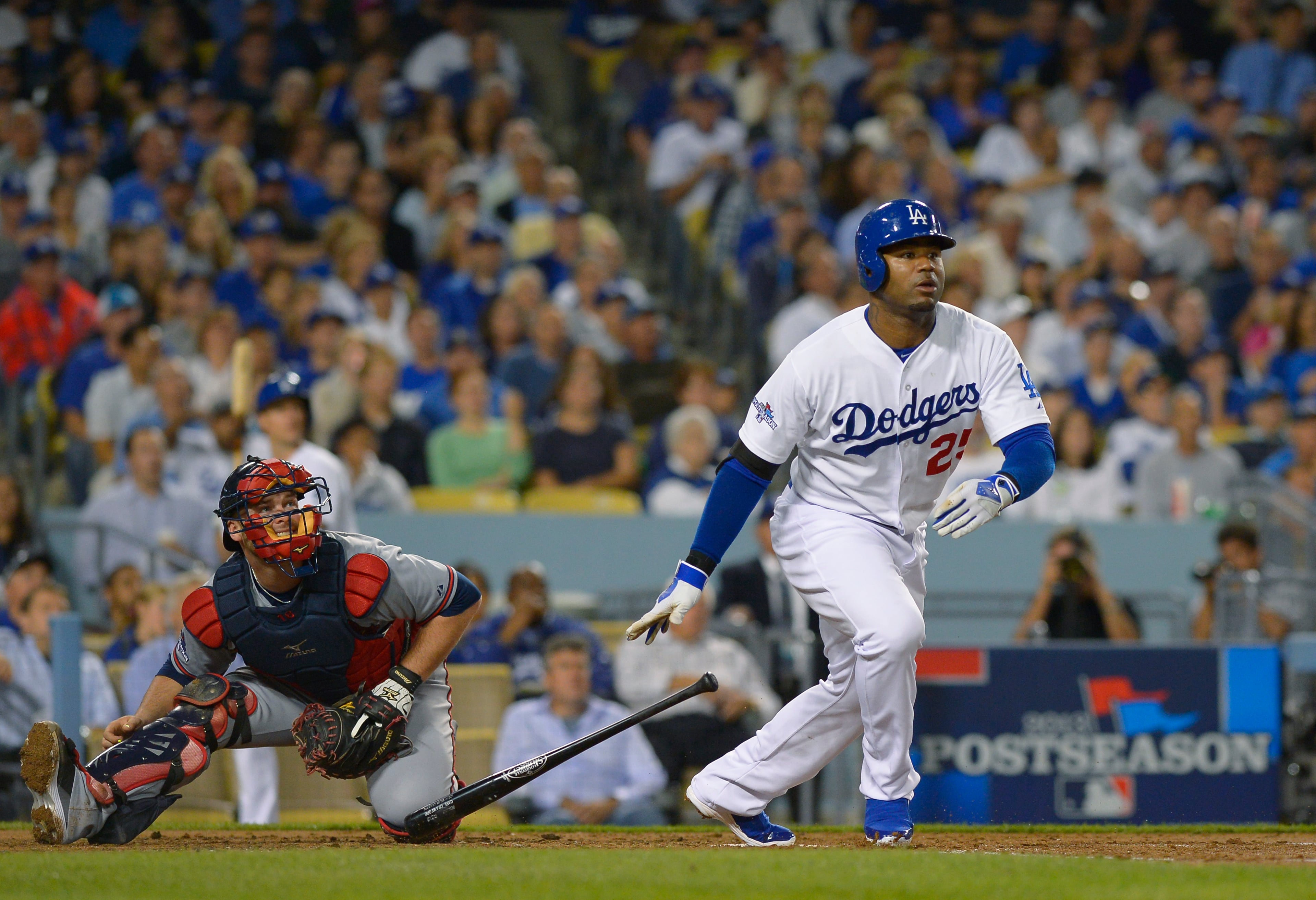 Los Angeles Dodgers' Carl Crawford, right, and Atlanta Braves catcher Brian McCann, left, watch Crawfod's solo home run take flight in the third inning of Game 4 in the National League division baseball series Monday, Oct. 7, 2013, in Los Angeles. It was Crawford's second home run of the game. (AP Photo/Mark J. Terrill)
